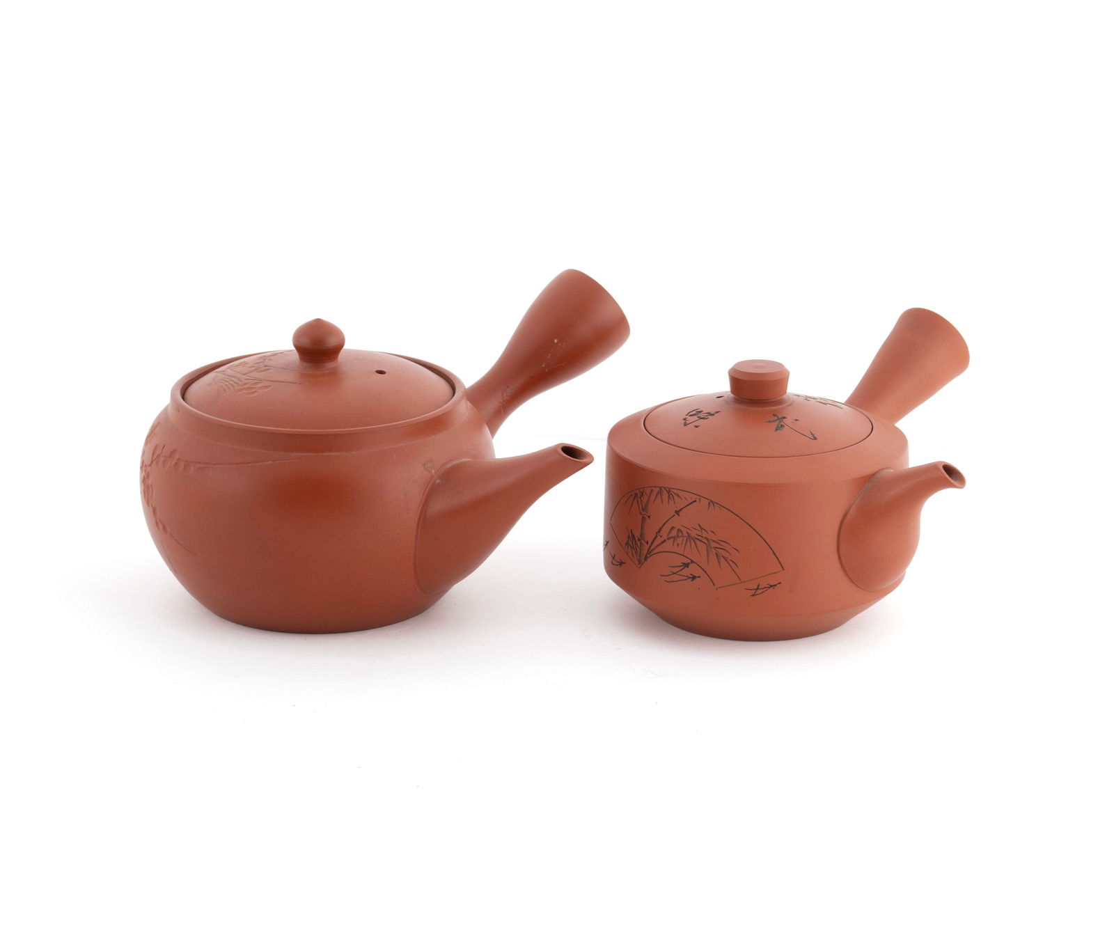 TWO KYUSU TEAPOTS: TWO KYUSU TEAPOTS Japanese, 20th century. Two double-spouted clay teapots with incised decoration, stamps under spout. Larger: 3 1/2 x 6 1/4 x 6 in. (8.9 x 15.9 x 15.2 cm.)