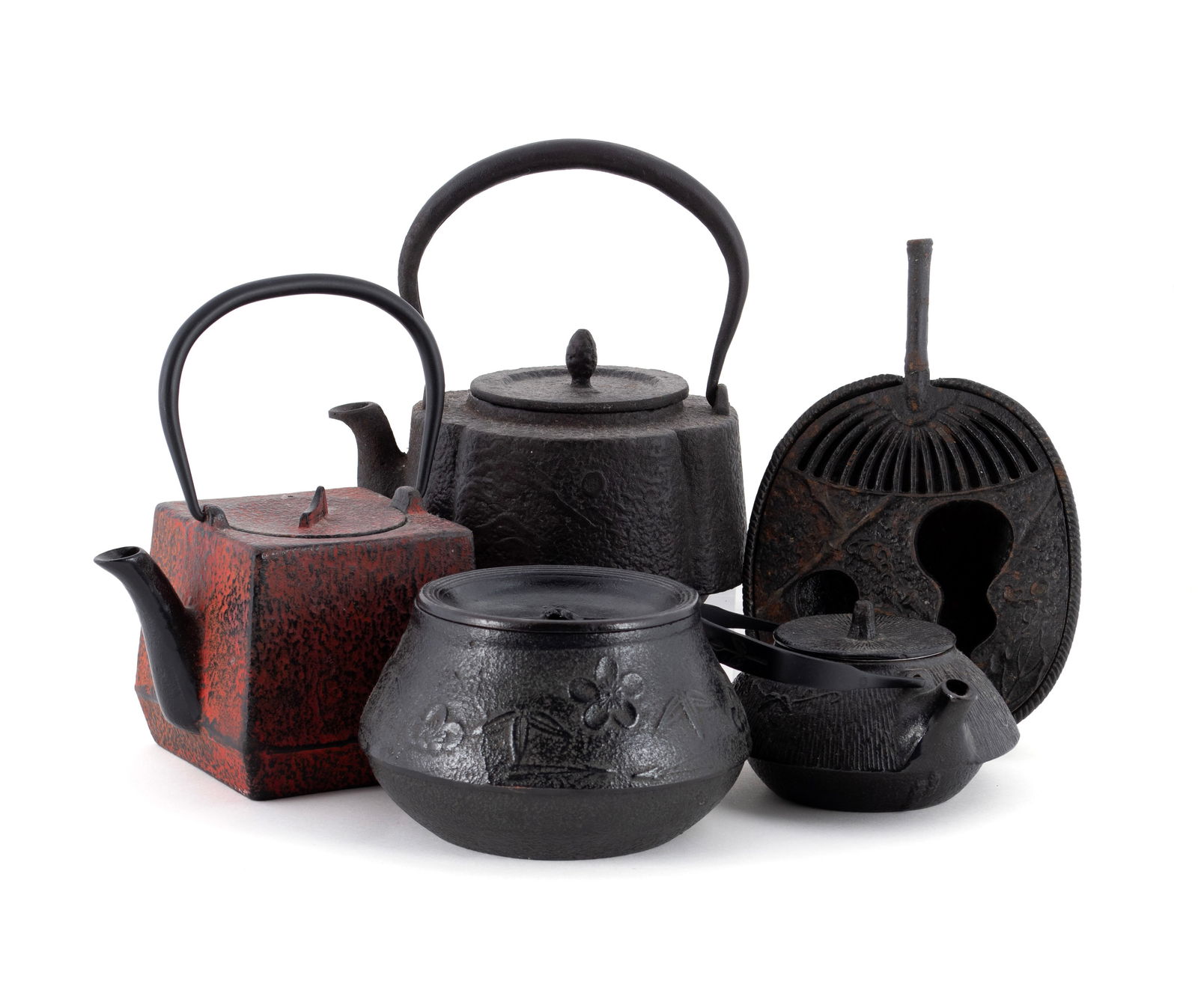 COLLECTION OF JAPANESE CAST IRON: COLLECTION OF JAPANESE CAST IRONFive (5) pieces of nanbu cast iron including a cherry blossom lidded bowl by Kaoruyama III, an incense burner, and three (3) teapots, one painted red and signed.Largest