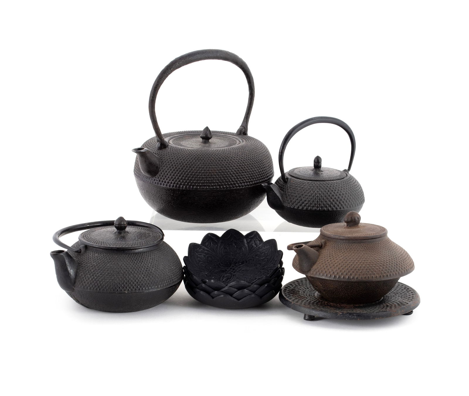 COLLECTION OF JAPANESE CAST IRON: COLLECTION OF JAPANESE CAST IRONTen (10) pieces total including four (4) tetsubin teapots, one with undertray, and five (5) petal form saucers.Largest (including handle): 7 3/4 x 7 1/2 x 6 in. (19.7 x