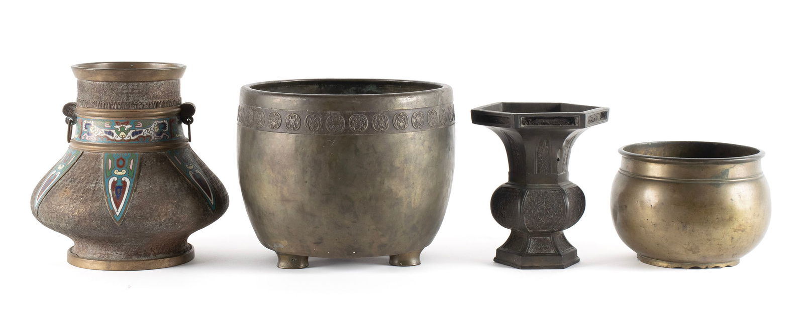 FOUR ASIAN DECORATIVE BRONZE VESSELS: FOUR ASIAN DECORATIVE BRONZE VESSELS Japanese and Chinese, 20th century, bronze. Includes a champleve highlighted double handled vase, a tri-footed jardiniere with incised decorative band near the