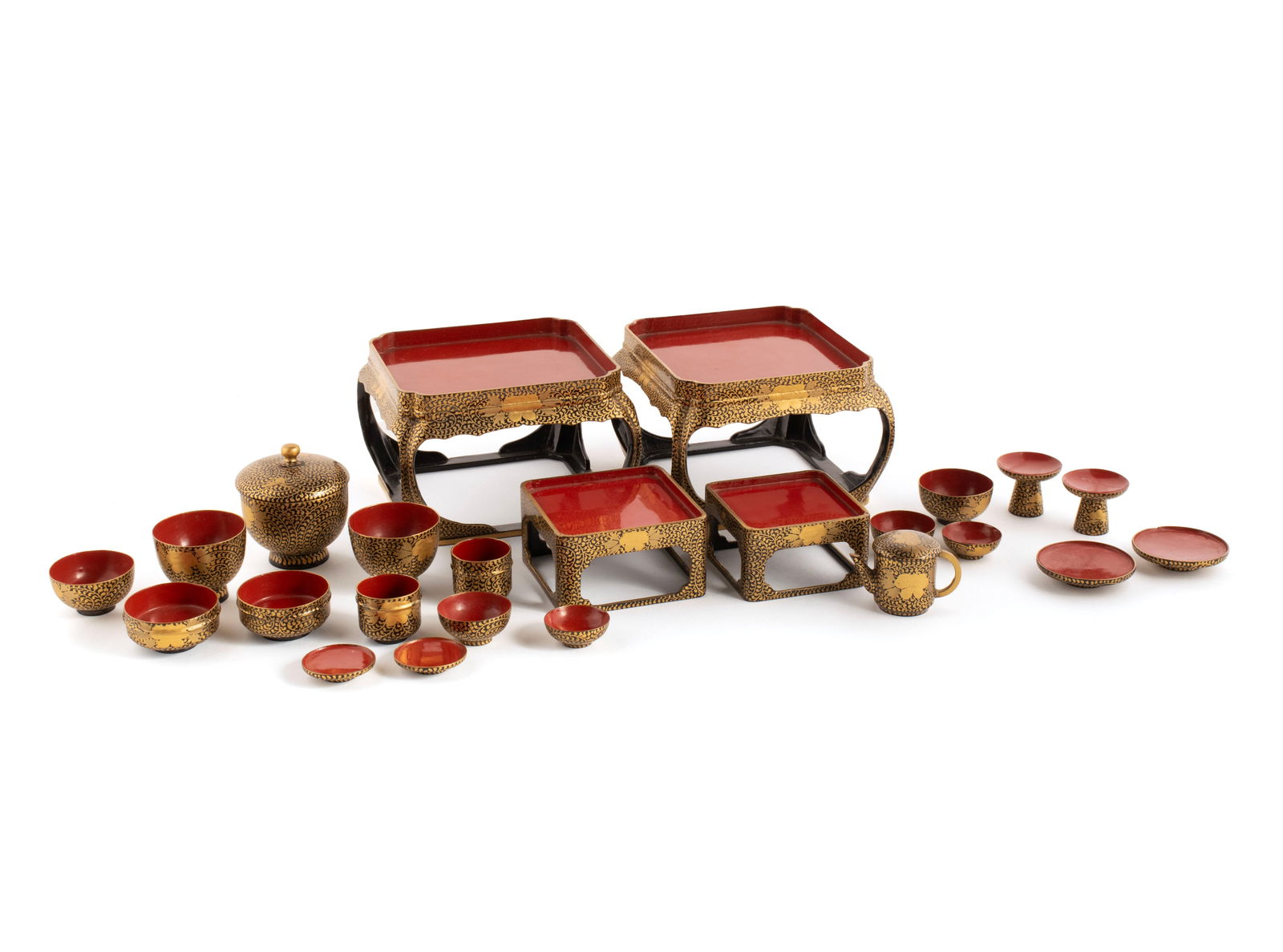 JAPANESE EIGHTEEN-PIECE CHILD'S LACQUERED TEA SET IN ORIGINAL BOX: JAPANESE EIGHTEEN-PIECE CHILD'S LACQUERED TEA SET IN ORIGINAL BOXMeiji. Black and gold lacquer tea set with red lacquer interiors consisting of two large tables, two smaller tables, fourteen assorted
