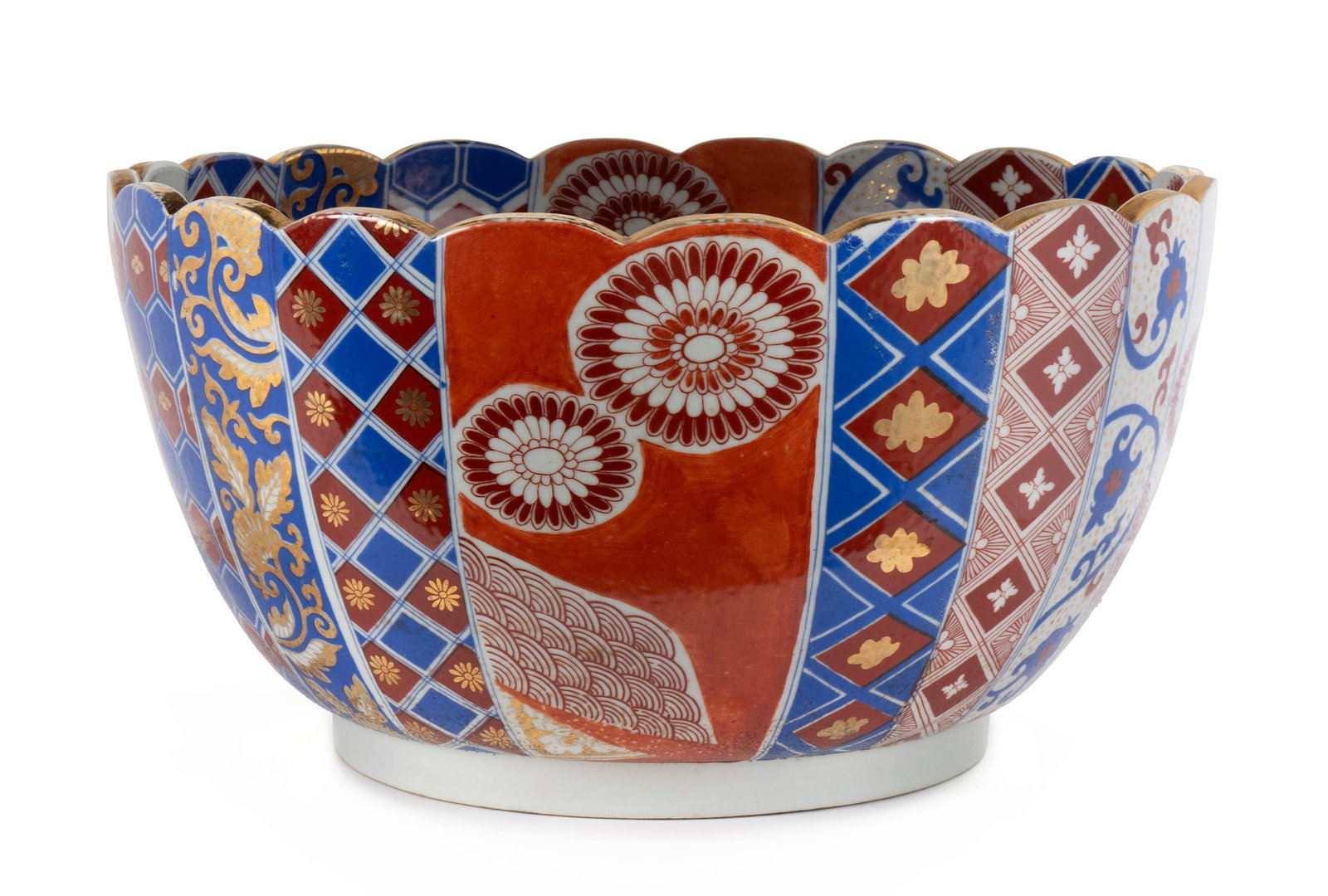 IMARI PORCELAIN PUNCH BOWL: IMARI PORCELAIN PUNCH BOWL Japanese, late 19th/early 20th century. Chrysanthemum form porcelain having individual painted paneled lobes with central floral spray. 8 1/2 x 16 in. (21.6 x 40.6 cm.)
