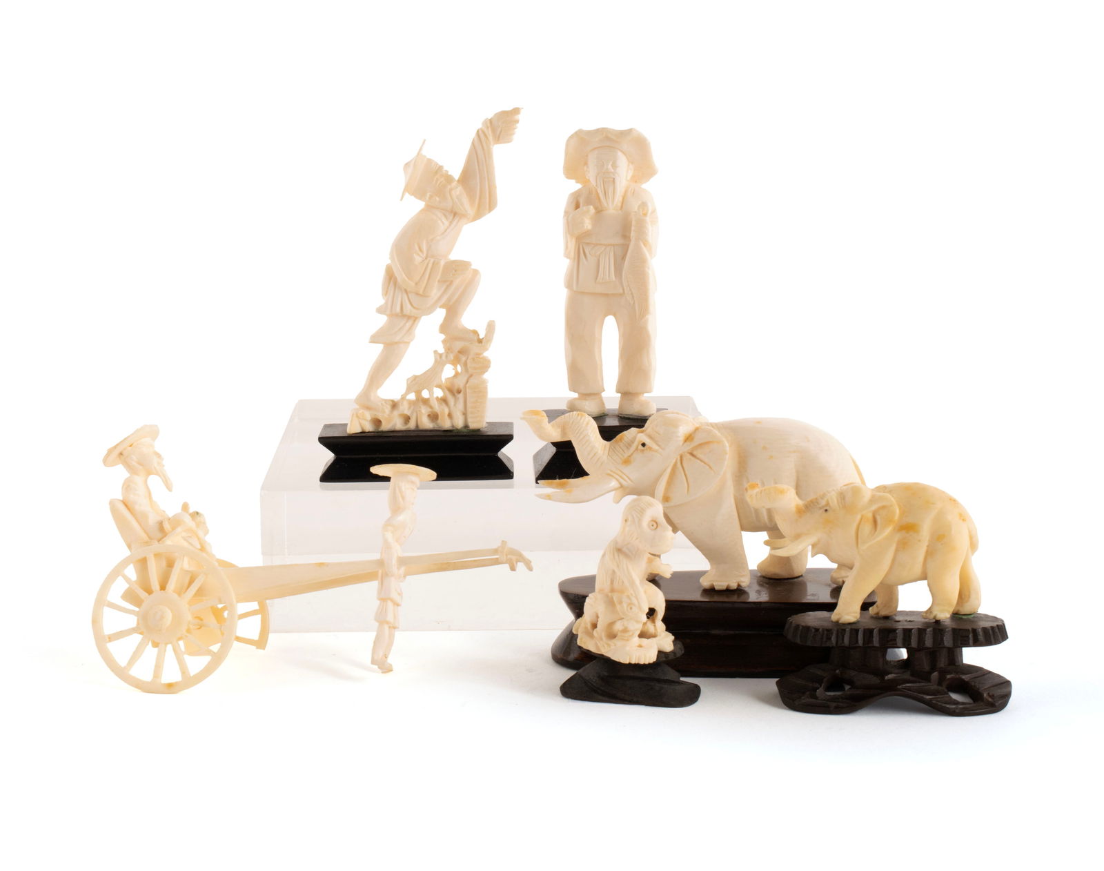 SIX ASIAN CARVED FIGURINES: SIX ASIAN CARVED FIGURINESEarly 20th century. Two (2) elephants, a monkey, two (2) standing men and a rickshaw drawn cart with figures (loss to wheel).Large elephant 1 1/2 x 3 1/2 x 1 in. (3.8 x 8.9 x