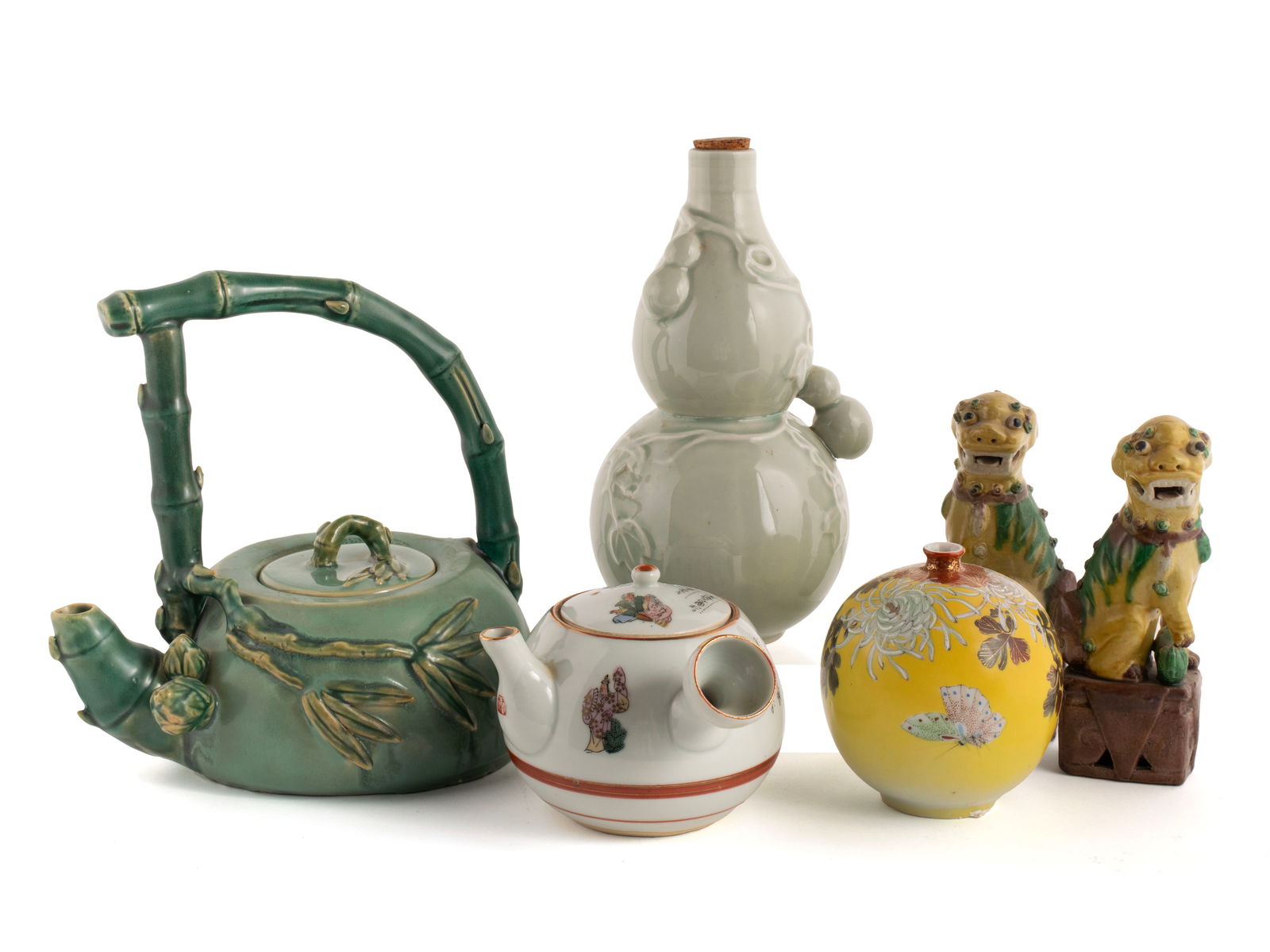 SIX PIECES OF ASIAN PORCELAIN: SIX PIECES OF ASIAN PORCELAIN20th century. Including a pair of early 20th century Chinese Export Sancai glazed foo dogs, a Chinese celadon double-gourd bottle, a Japanese satsuma yellow vase, Japanese
