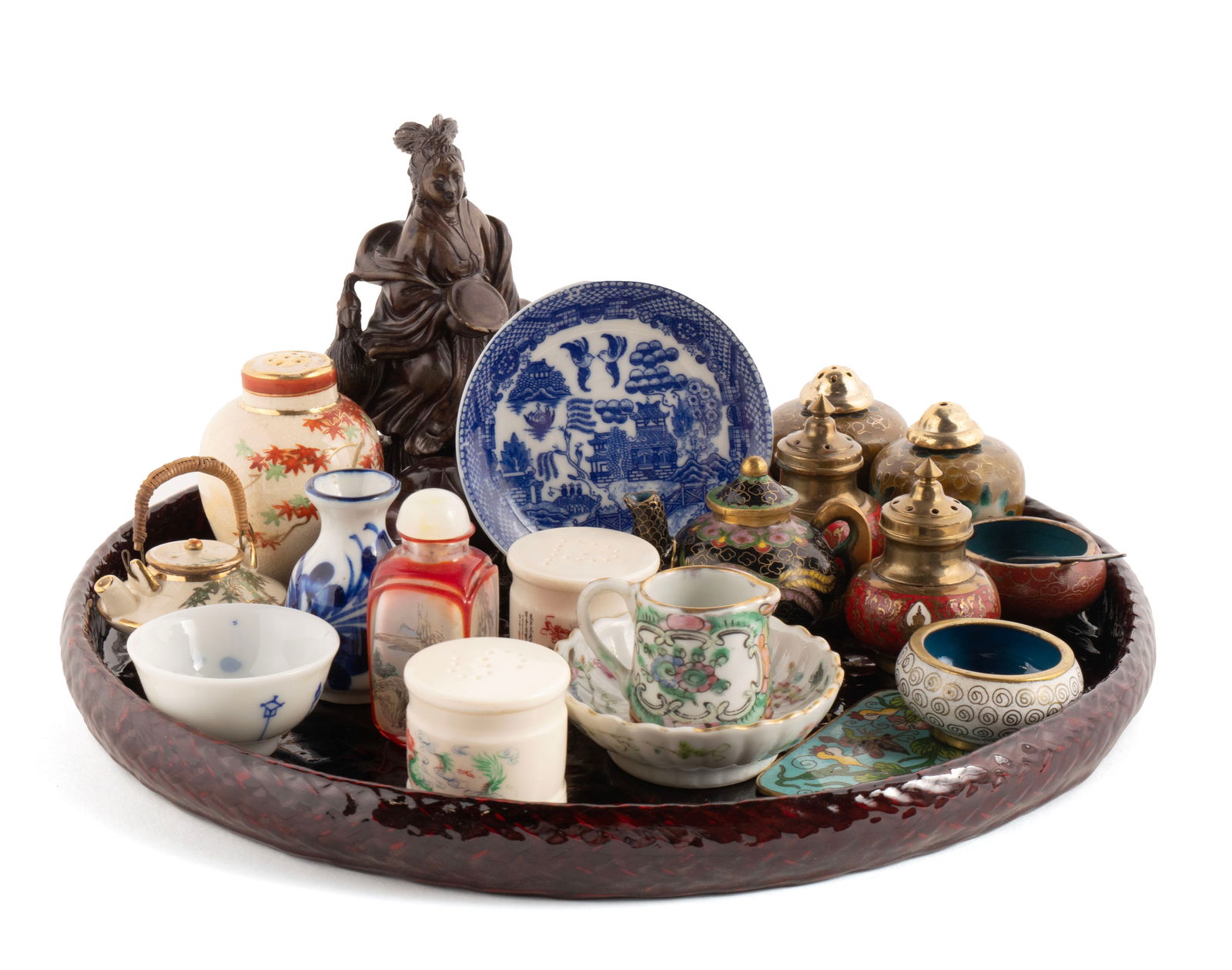 TWENTY-ONE PIECES OF DIMINUTIVE ASIAN DECORATIVE ART: TWENTY-ONE PIECES OF DIMINUTIVE ASIAN DECORATIVE ART20th century. Including one (1) circular red lacquer tray, one (1) stained soapstone figure of Guanyin on fitted wood stand, (5) five assorted clois