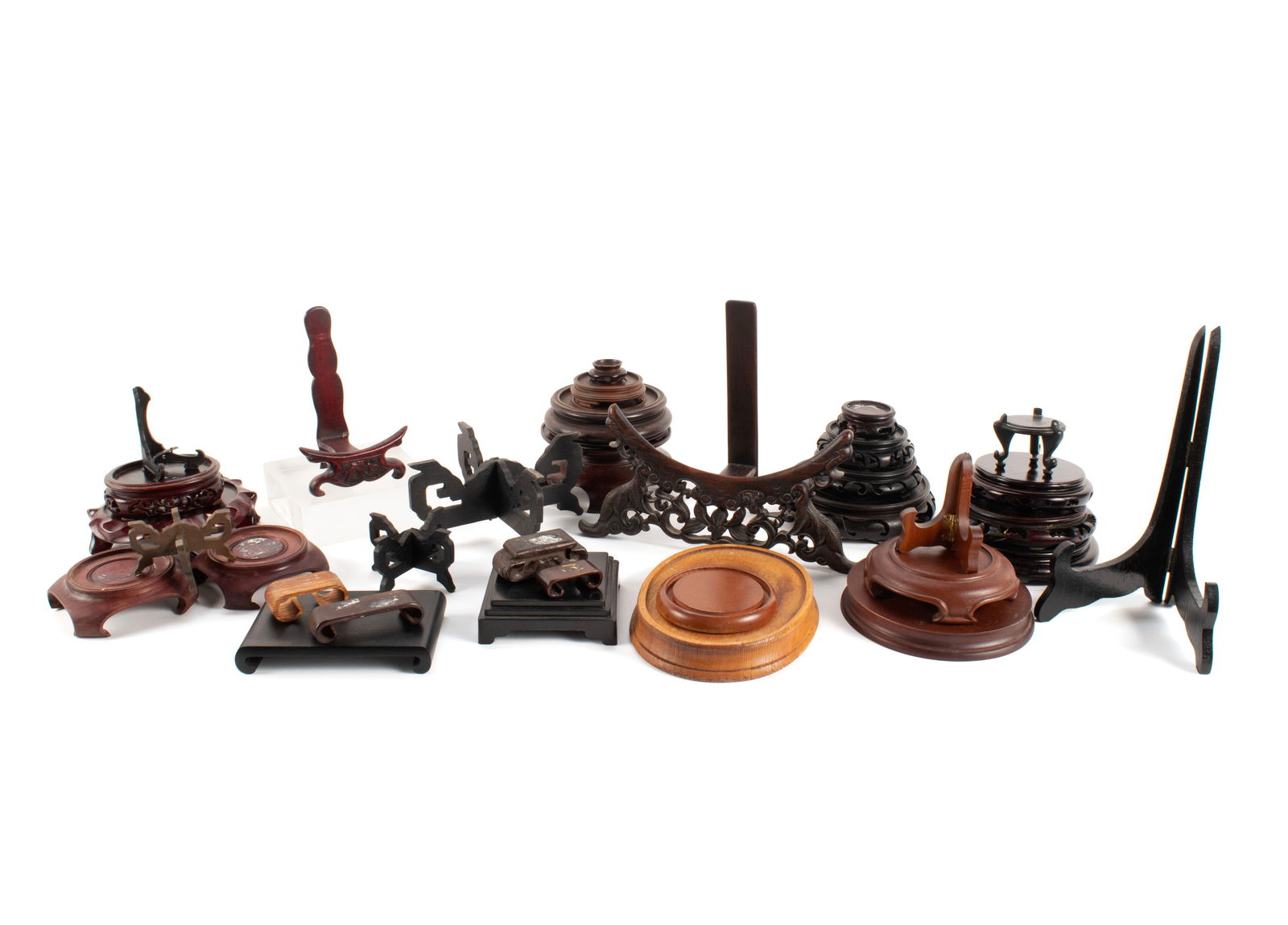 THIRTY-THREE ASSORTED WOOD STANDS: THIRTY-THREE ASSORTED WOOD STANDS 20th century, mostly Asian, including carved plate stand. plate stand 8 x 10 x 4 in. (20.3 x 25.4 x 10.2 cm.)