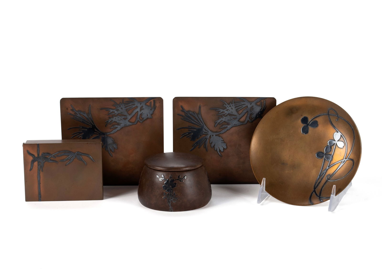 COLLECTION OF HEINTZ ART METAL: COLLECTION OF HEINTZ ART METALAmerican, early 20th century. Five pieces, all sterling on bronze, including a pair of bookends, a plate, and two lidded boxes, all marked.Bookends: 5 x 5 1/2 x 4 in. (12