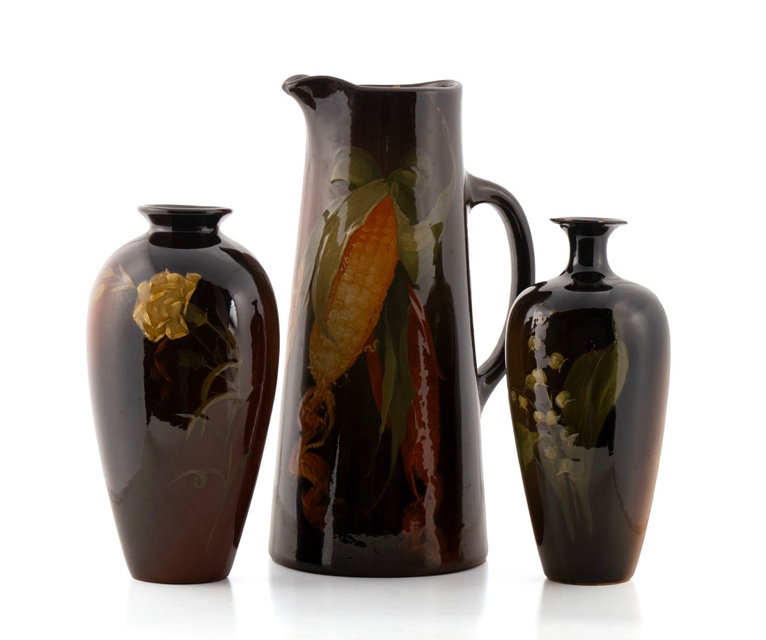 THREE WELLER 'LOUWELSA' PIECES: THREE WELLER 'LOUWELSA' PIECESAmerican, early 20th century. Three standard glaze pottery pieces including two vases with floral decoration, and a pitcher with corn. All marked on underside, and the pi