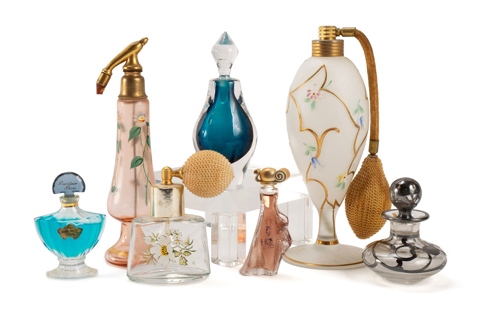 COLLECTION OF DECORATIVE GLASS PERFUME BOTTLES AND ATOMIZERS: COLLECTION OF DECORATIVE GLASS PERFUME BOTTLES AND ATOMIZERS 20th century. Seven (7) total including several painted and a silver overlay example. Largest: 7 in. (17.8 cm.)