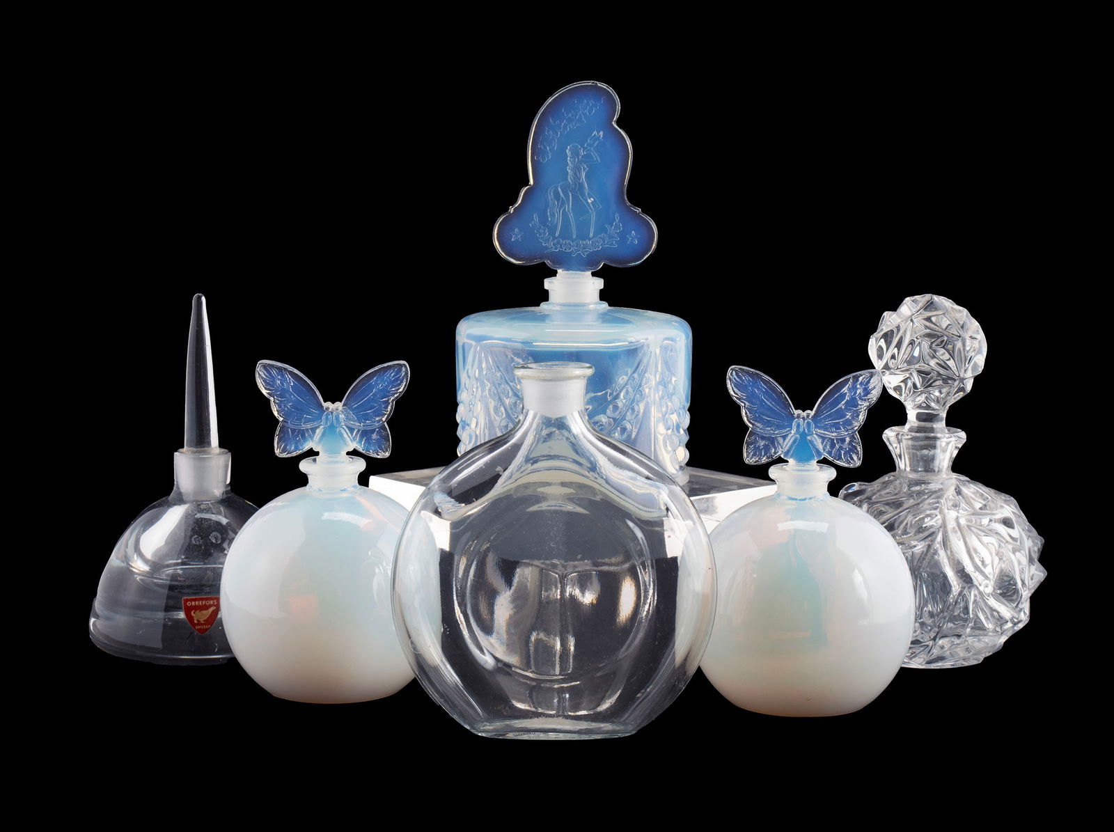 COLLECTION OF DECORATIVE GLASS PERFUME BOTTLES: COLLECTION OF DECORATIVE GLASS PERFUME BOTTLES20th century. Six (6) total, including Tiffany & Co., Orrefors, Guerlain and Sabino.Largest: 5 1/4 in. (13.3 cm.)