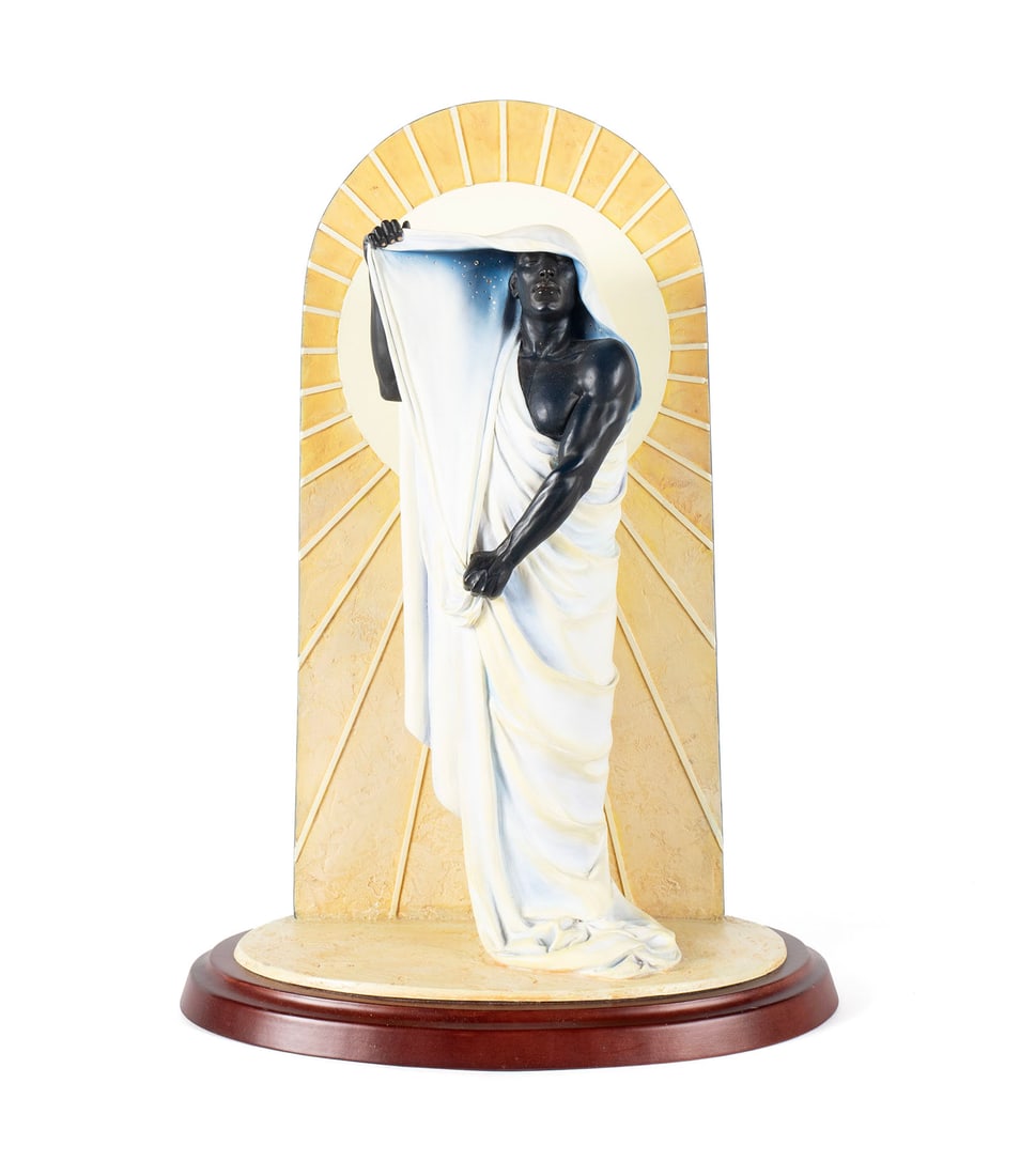 THOMAS BLACKSHEAR NIGHT IN DAY EBONY VISIONS FIGURINE: THOMAS BLACKSHEAR NIGHT IN DAY EBONY VISIONS FIGURINELimited Edition First Issue 2,570/3,500, composition, with COA. Black figure draped on a long wrap, against an arched sun-like background, the back
