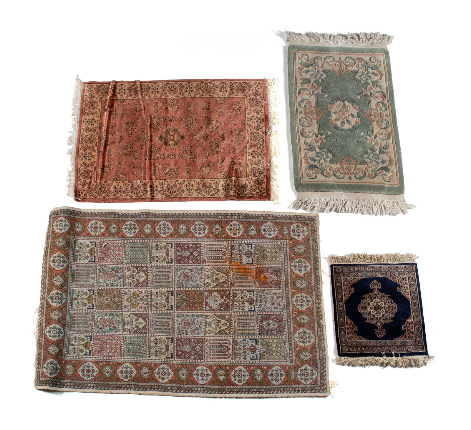 FOUR TEXTILE RUGS: FOUR TEXTILE RUGSThe largest a colorful flat woven garden panel design that shows wear. The smallest a navy field mat centering a pole medallion with geometric border. Another is a celadon green flora