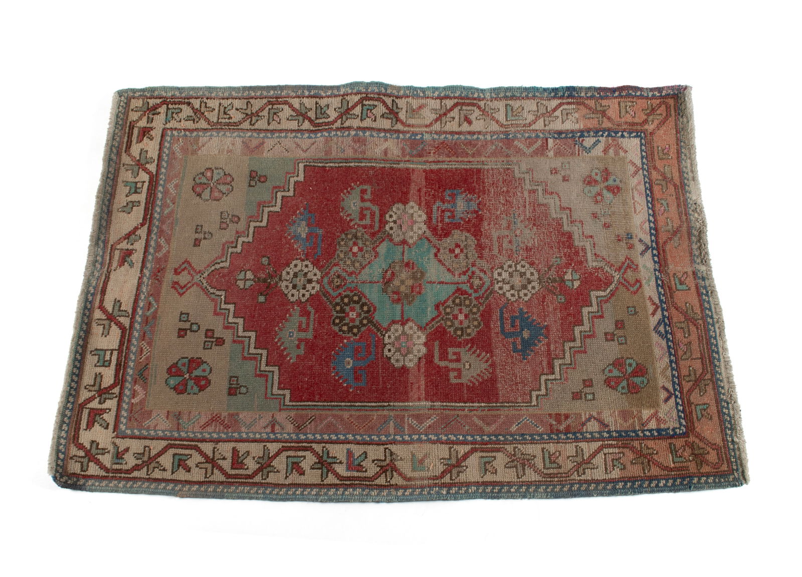 OUSHAK AREA RUG: OUSHAK AREA RUG Turkish, mid-20th century. Blue foliate medallion on the red field with abrash tan end panels, ivory border with guard borders, shows wear. 4 ft. 7 in. x 3 ft. 4 in.