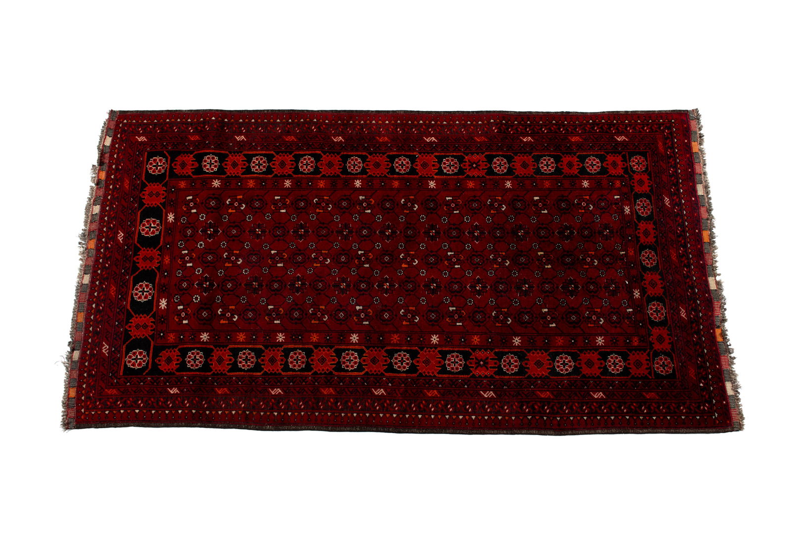 TURKOMAN AREA RUG: TURKOMAN AREA RUG Turkish, 20th century. Red field of repetitive rows of foliate medallions surrounded by a near black border with red, orange and ivory highlights, with multiple outer borders. 6 ft.