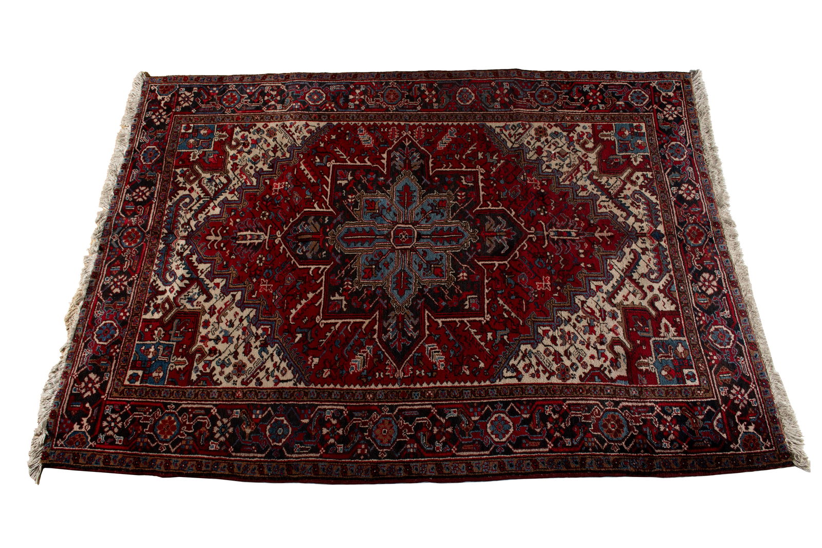 HERIZ HALL RUG: HERIZ HALL RUG Persian, 20th century. Sky blue on navy foliate medallion centers the floral decorated red field with ivory end panels showing red to blue corners, navy border with soft brown guard