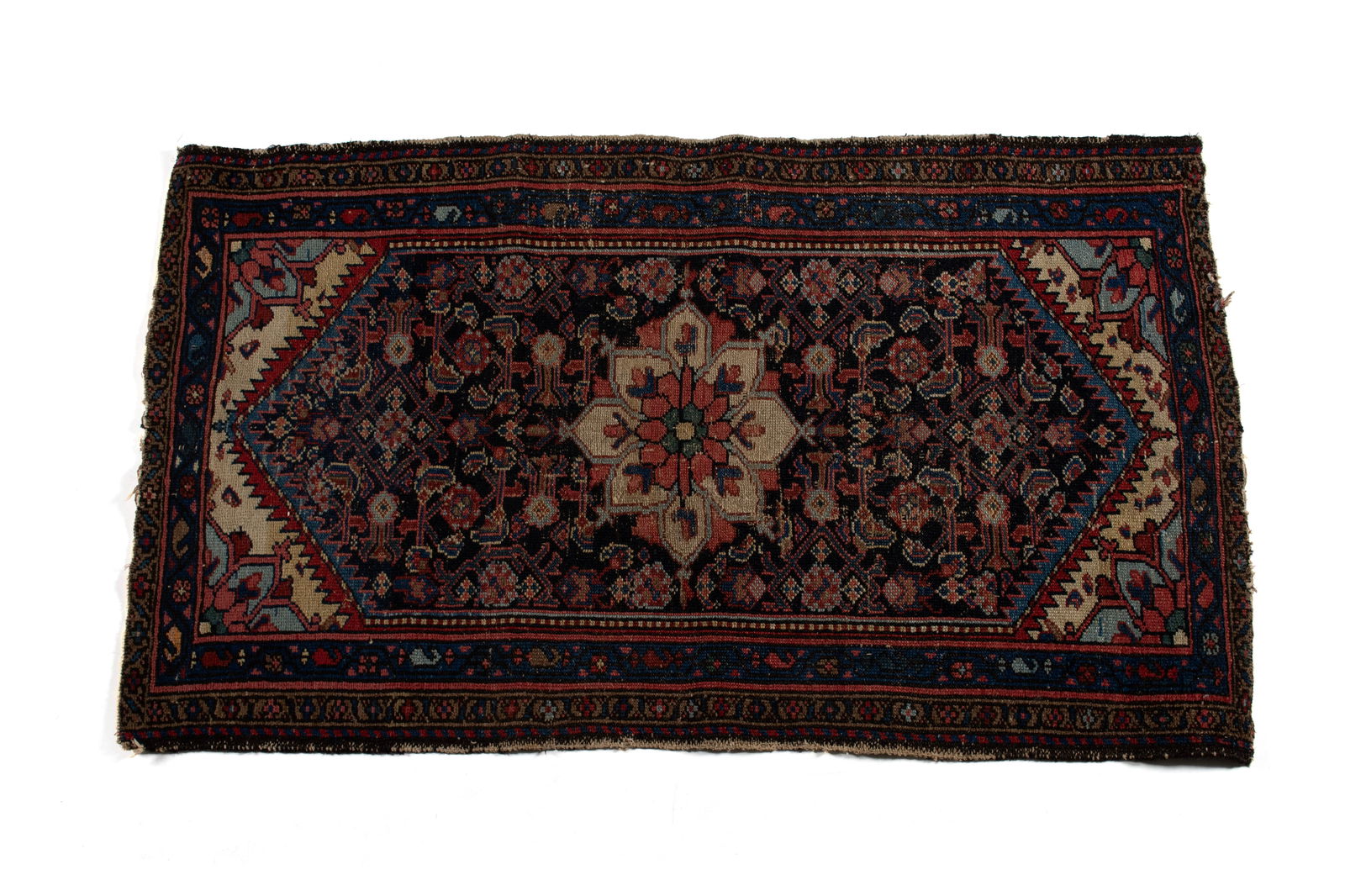 MALAYER AREA RUG: MALAYER AREA RUGPersian, early 20th century. Red on ivory floral medallion centers the foliate decorated navy field showing red, ivory and blue angled end panels with sawtooth bordering, multiple bord