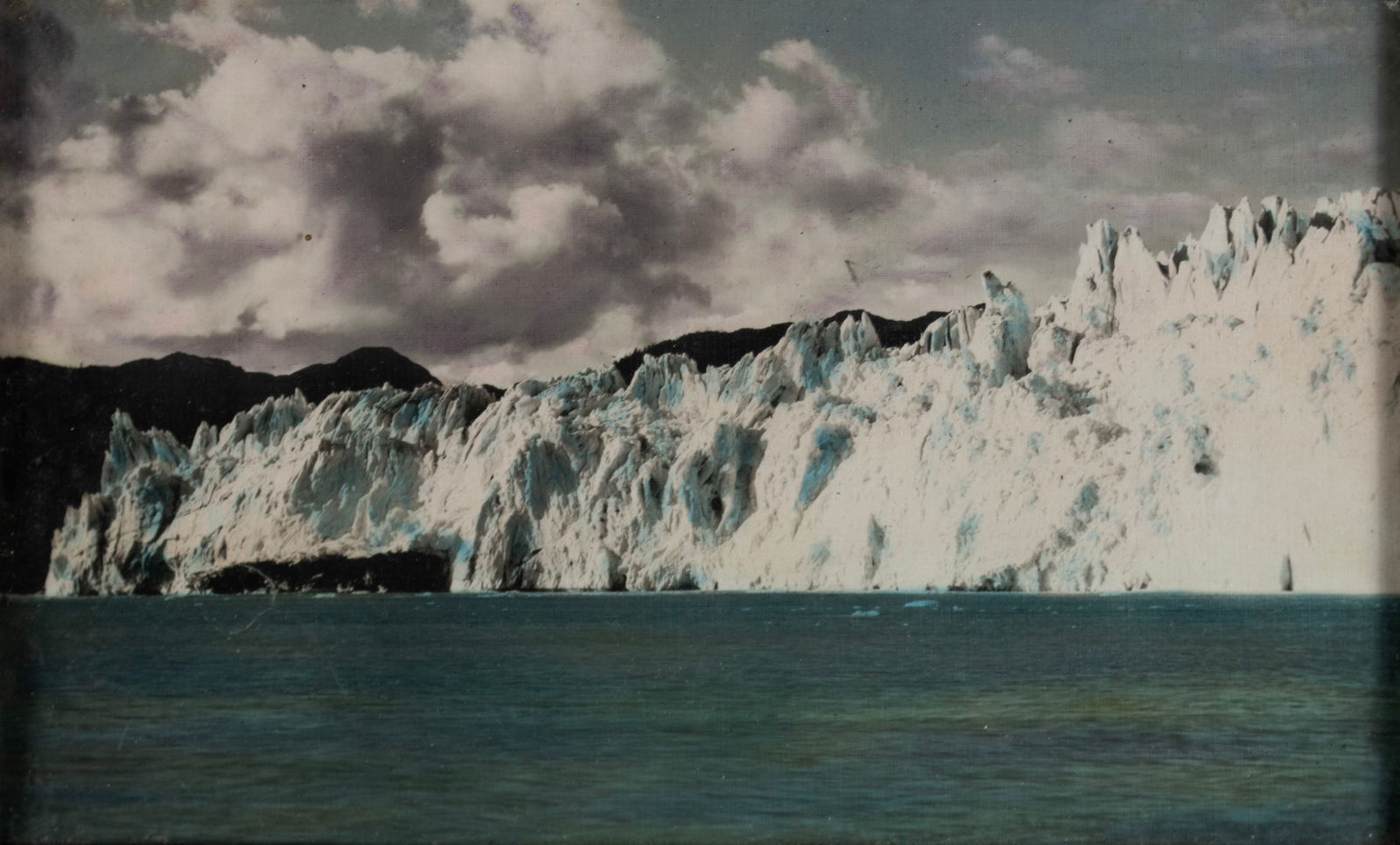 WILLIAM ERNEST LOGEMANN (AMERICAN (ALASKA), 1885-1952): William Ernest Logemann American (Alaska), 1885-1952 Photograph Circa 1920. Sticker affixed verso for W. E. Logemann, Anchorage, Alaska. Image of a glacier as taken from the sea, framed. Sight: 5 3/4