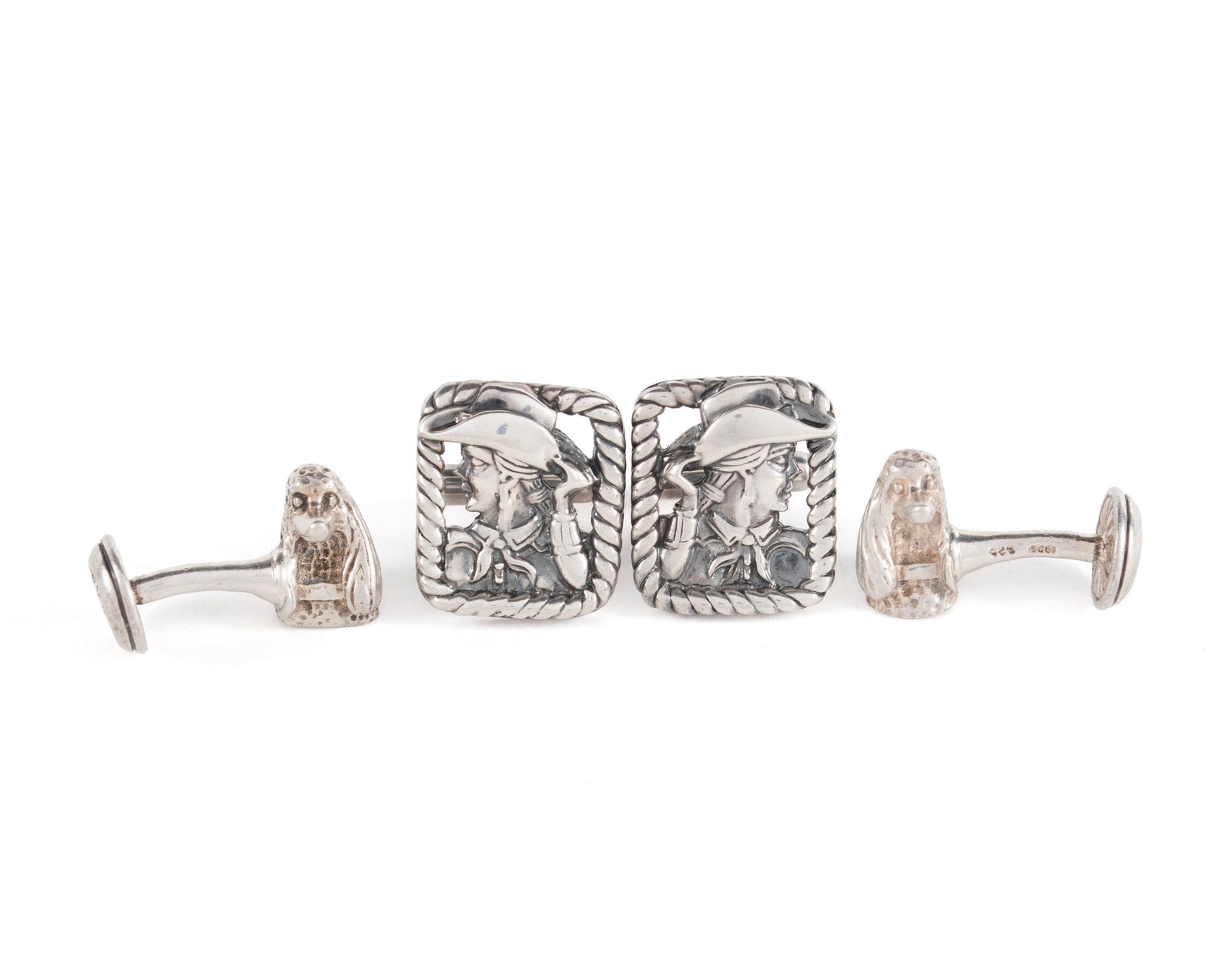 TWO PAIR OF STERLING SILVER KIESELSTEIN-CORD CUFFLINKS: TWO PAIR OF STERLING SILVER KIESELSTEIN-CORD CUFFLINKSBoth signed and marked 925, the dog head cufflinks dated 1999. One pair showing the head of a long-haired poodle and showing the moon and a star o
