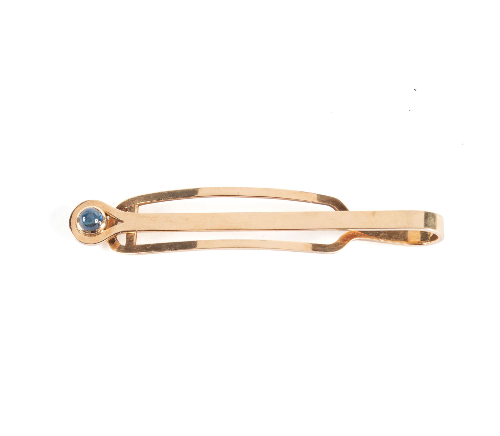 YELLOW GOLD TIE BAR: YELLOW GOLD TIE BARMarked 14K, with a light blue cabochon stone to the tip. Total weight 5 grams.2 1/4 in. (5.7 cm.)