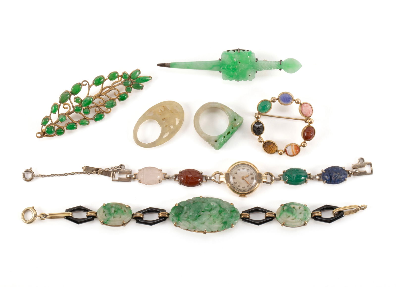 SEVEN PIECES OF JADE JEWELRY: SEVEN PIECES OF JADE JEWELRYIncludes an "E. Mathey Tissot & Co." watch with four colorful inset stones to the band, oval jadeite ring with foliate highlights, another jadeite ring, unmarked foliate br