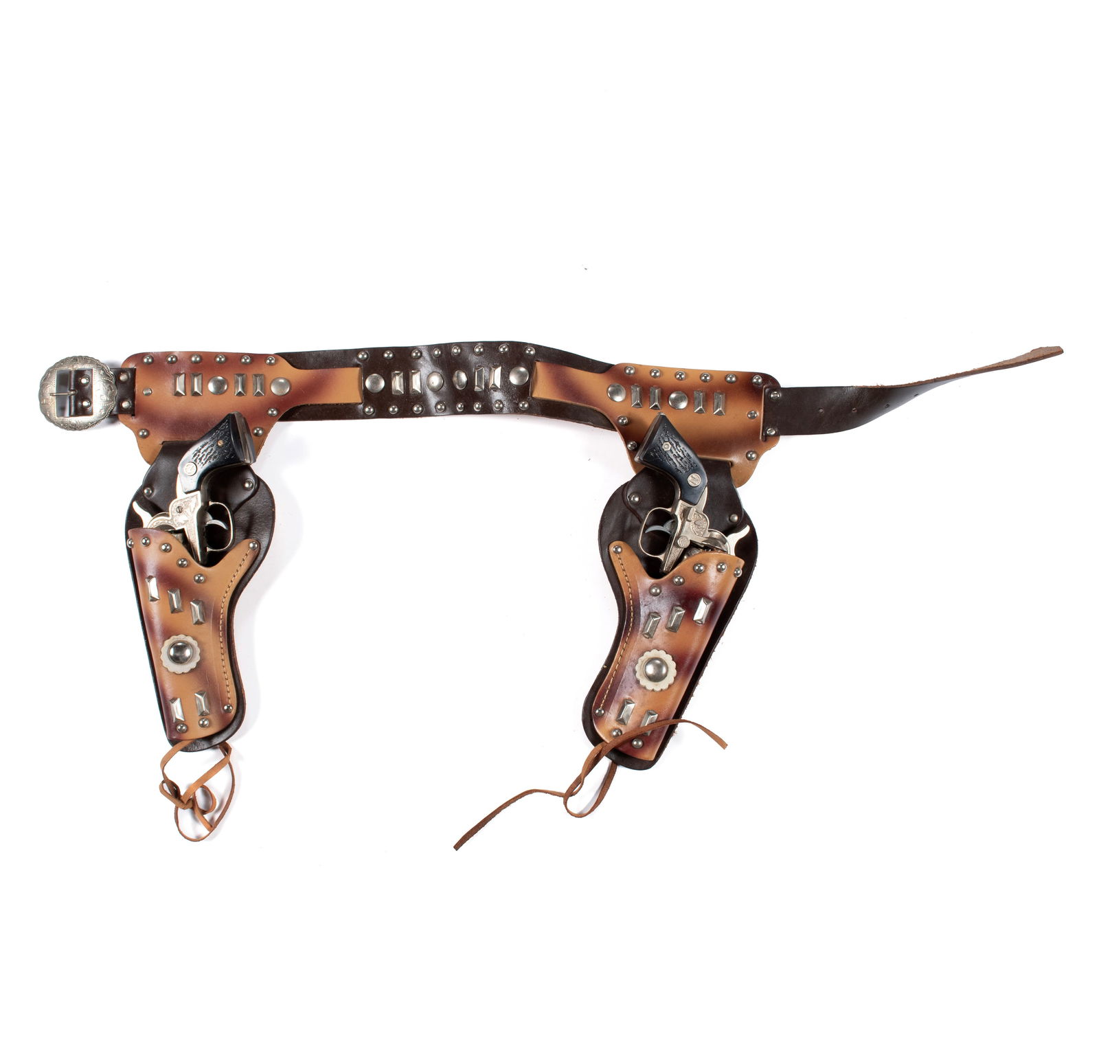 PAIR OF NICHOLS STALLION .32 CAL CAP GUNS WITH HOLSTER: PAIR OF NICHOLS STALLION .32 CAL CAP GUNS WITH HOLSTERAmerican (Texas), mid-20th century, NOS. Ebonized grips, likely never fired, leather holster also excellent.Cap guns: 8.69 in. (22.1 cm.), Holster