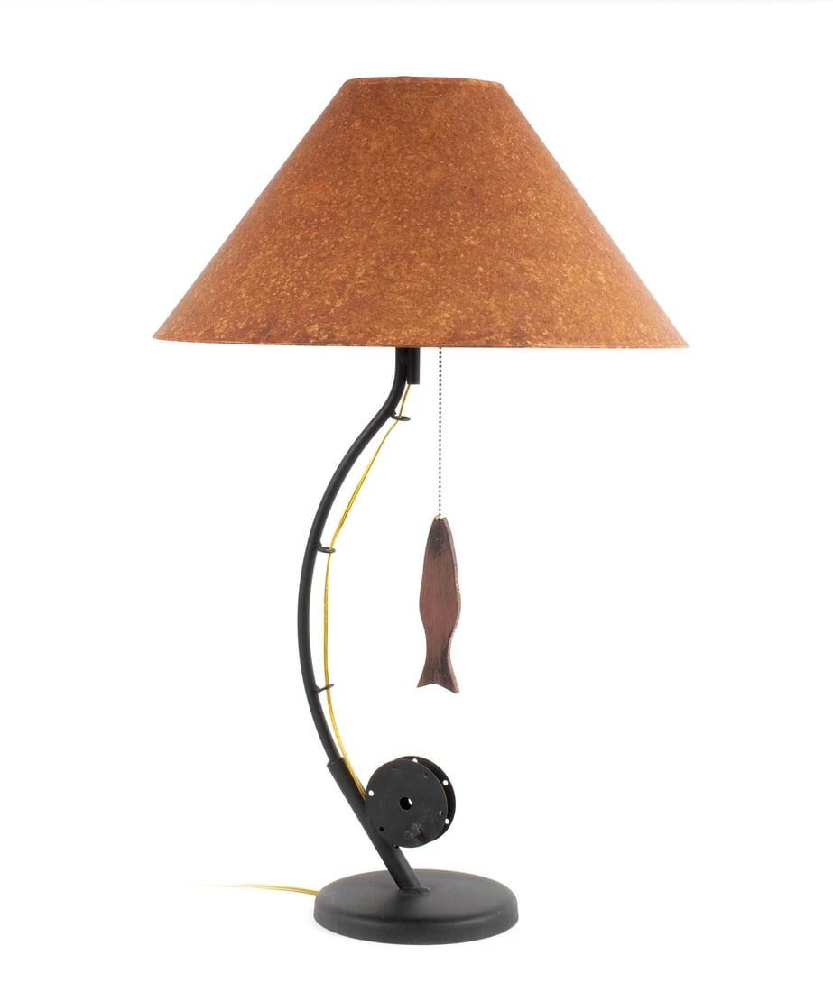 FISHING THEMED TABLE LAMP: FISHING THEMED TABLE LAMPAmerican, 20th century. Standard is in the form of a bowed fishing rod, dangling a fish from the tip, circular base.31 1/2 x 20 in. (80 x 50.8 cm.)
