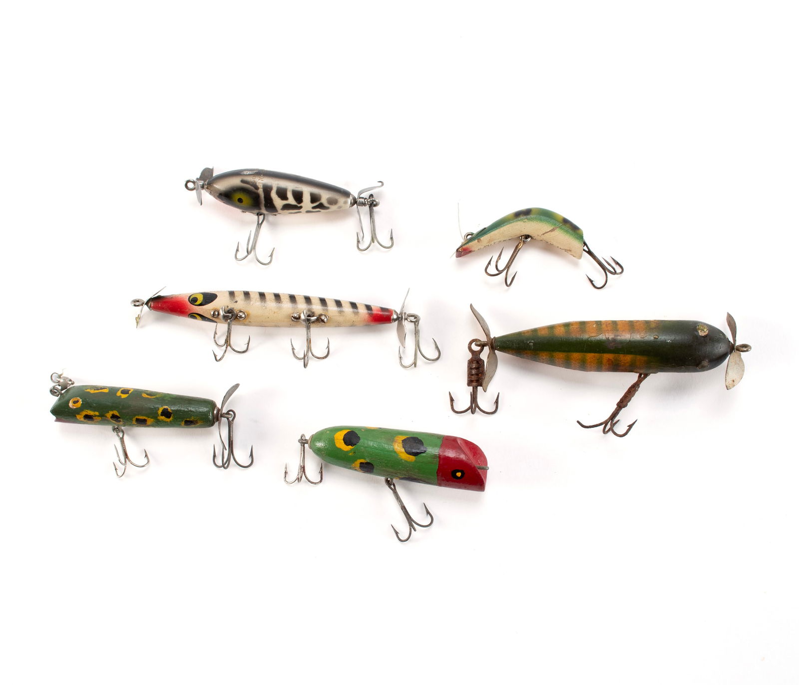 SIX WOODEN FISHING LURES: SIX WOODEN FISHING LURESAmerican, mid-20th century, all with painted highlights. Includes a Smithwick Devils Horse, Heddon Wounded Spook, Kautzky Lazy Ike, South Bend Spin-I-Diddee, and two others tha