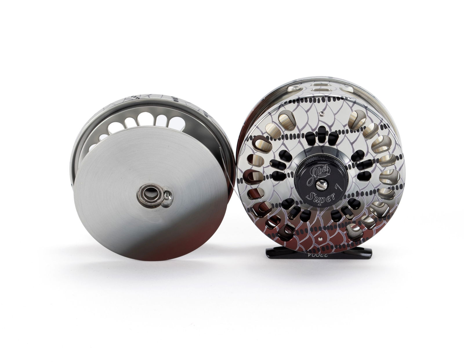 ABEL SUPER 7 FLY FISHING REEL WITH SPARE REEL: ABEL SUPER 7 FLY FISHING REEL WITH SPARE REELAmerican, # 2204, hand painted on aluminum with fish scale finish.Diameter: 3 3/4 in. (9.5 cm.)
