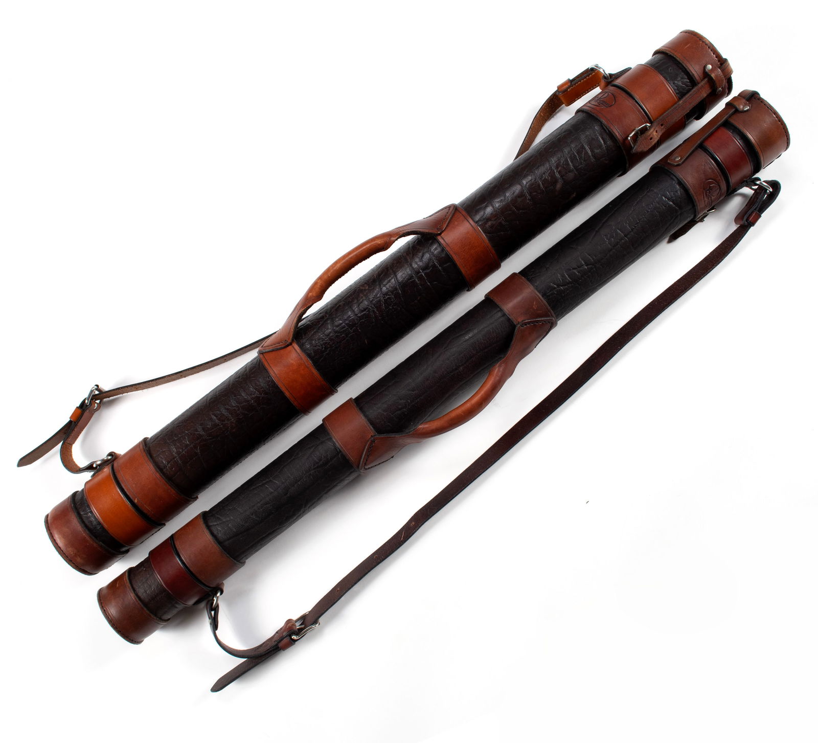TWO RIVERMAN LEATHER ROD TUBES: TWO RIVERMAN LEATHER ROD TUBESWith tooled alligator-like finish, both with carrying handles and shoulder straps. One 4.25" and 3.75" diameter.40 1/2 in. (102.9 cm.)