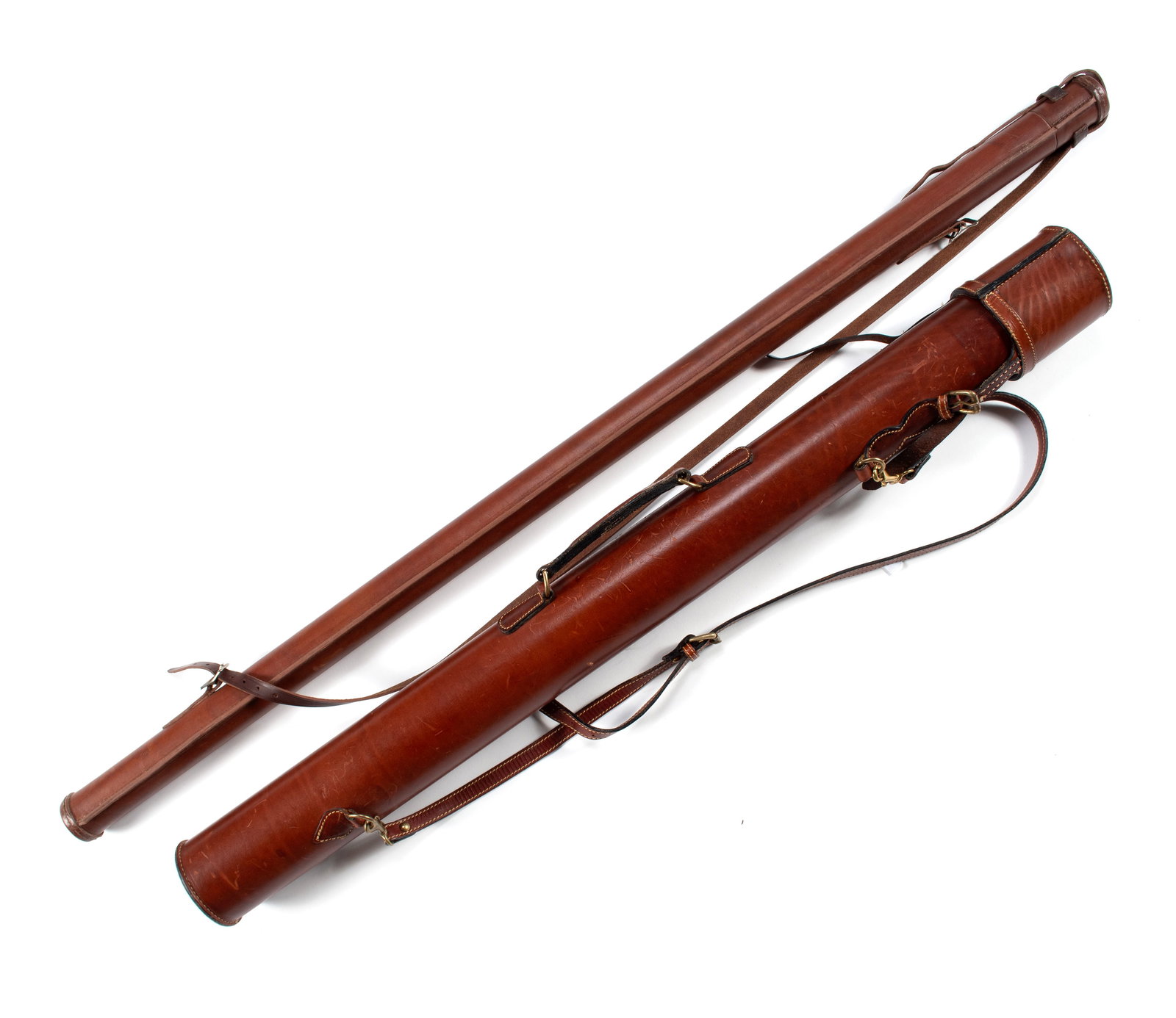 TWO LEATHER ROD TUBES: TWO LEATHER ROD TUBES Both unmarked with shoulder straps, the larger tube with handle. 48 1/2 x 2 x 2 in. (123.2 x 5.1 x 5.1 cm.), and: 39 1/4 x 3 3/4 x 3 3/4 in. (99.7 x 9.5 x 9.5 cm.)