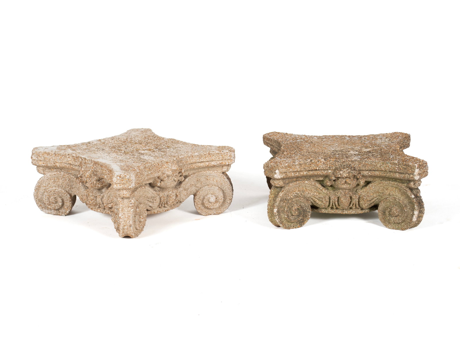 PAIR OF CORINTHIAN CAPITAL FORM PEDESTALS: PAIR OF CORINTHIAN CAPITAL FORM PEDESTALS American, mid-20th century, concrete. Square with concave sides over the decorative casts, on scrolling feet. Each: 5 3/4 x 13 1/2 x 13 1/2 in. (14.6 x 34.3 x