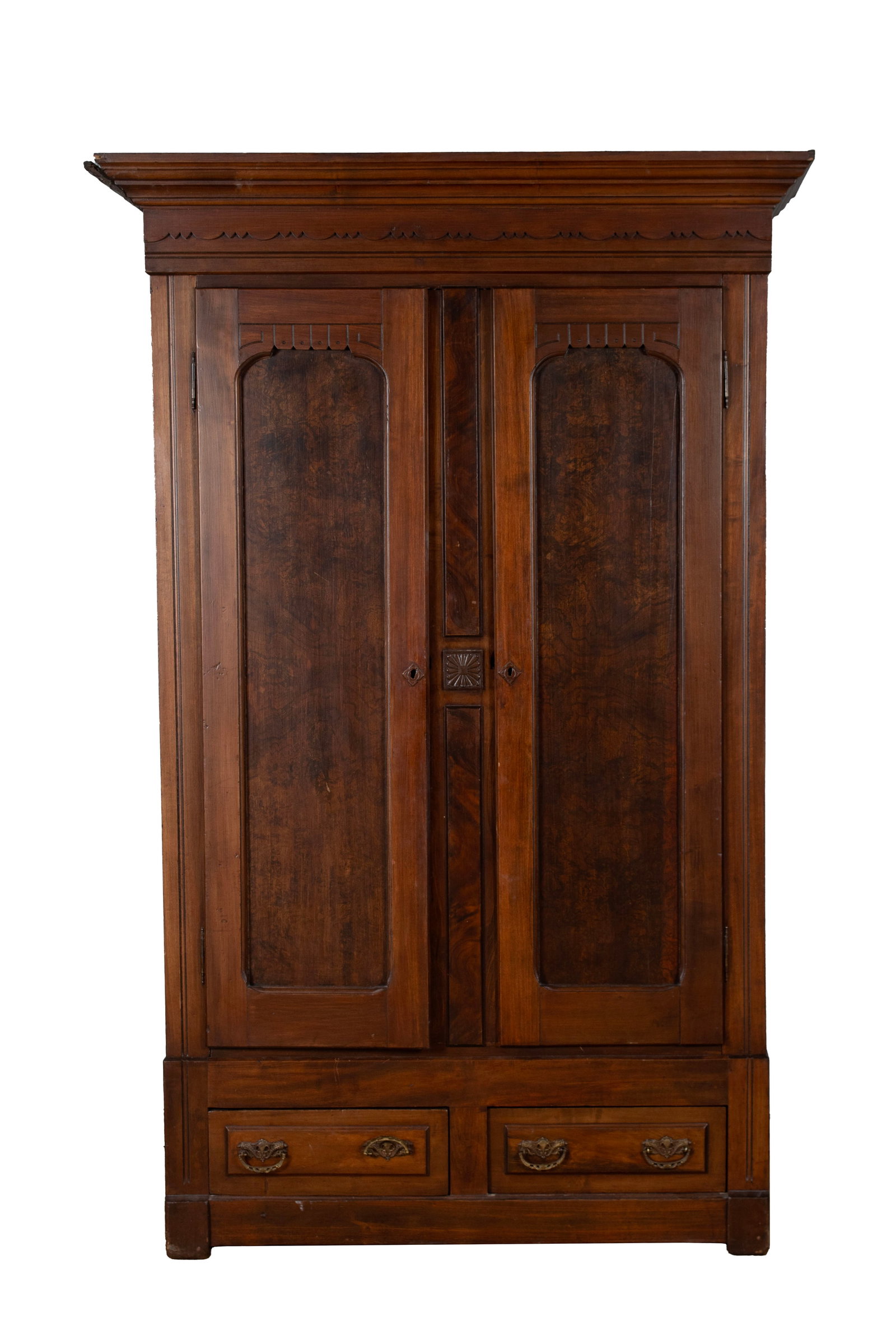 AMERICAN KNOCKDOWN WARDROBE: AMERICAN KNOCKDOWN WARDROBE 19th century, walnut. Victorian wardrobe with stepped cornice over two long paneled doors, and two aligned drawers, with carved details. 85 x 21 1/4 x 54 in. (215.9 x 54 x