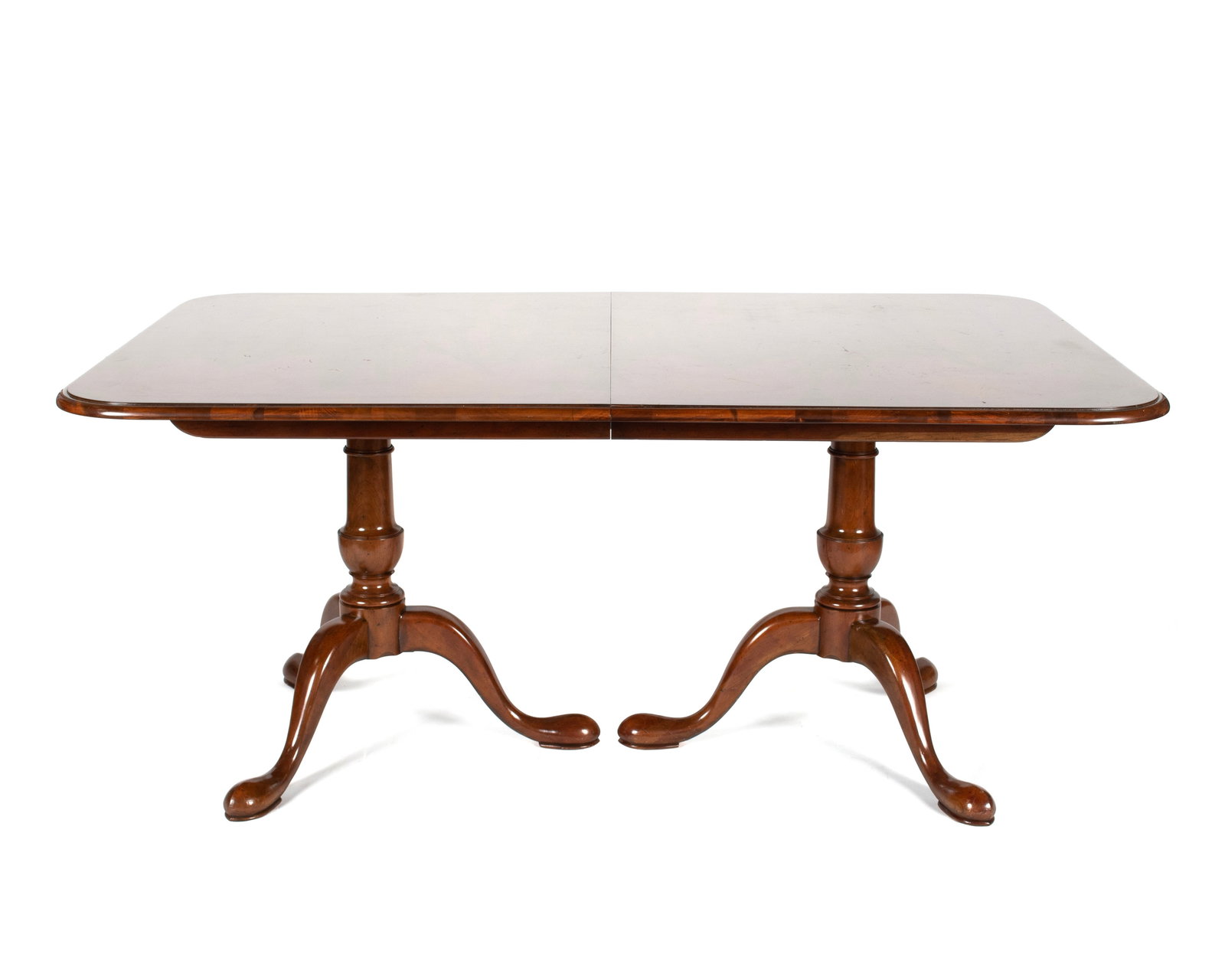 GEORGIAN STYLE DINING TABLE BY BAKER: GEORGIAN STYLE DINING TABLE BY BAKER American, 20th century, mahogany. Rectangular crossbanded top with rounded corners, on the twin pedestal supports with vasiform pedestals and tripod legs with