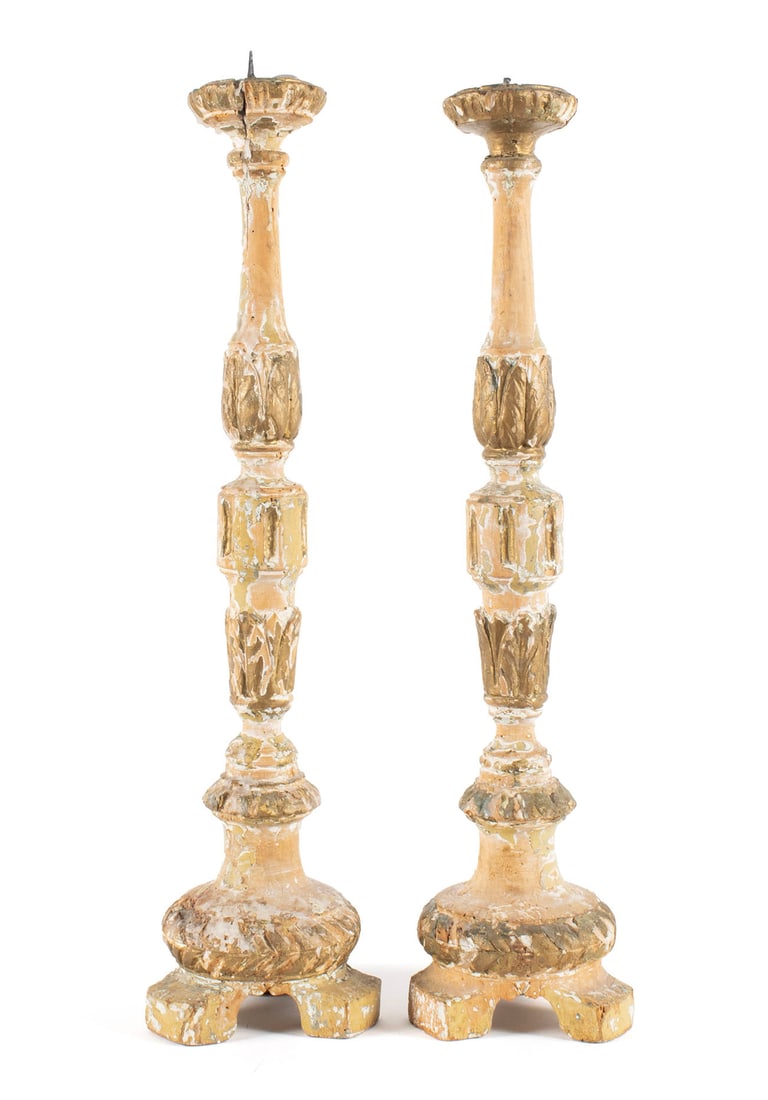 PAIR OF PAINTED AND GILT PRICKET CANDLESTICKS: PAIR OF PAINTED AND GILT PRICKET CANDLESTICKS Wooden carved pricket candlesticks with remnants of gesso and gilding. Each: 20 1/2 in. (52.1 cm.)
