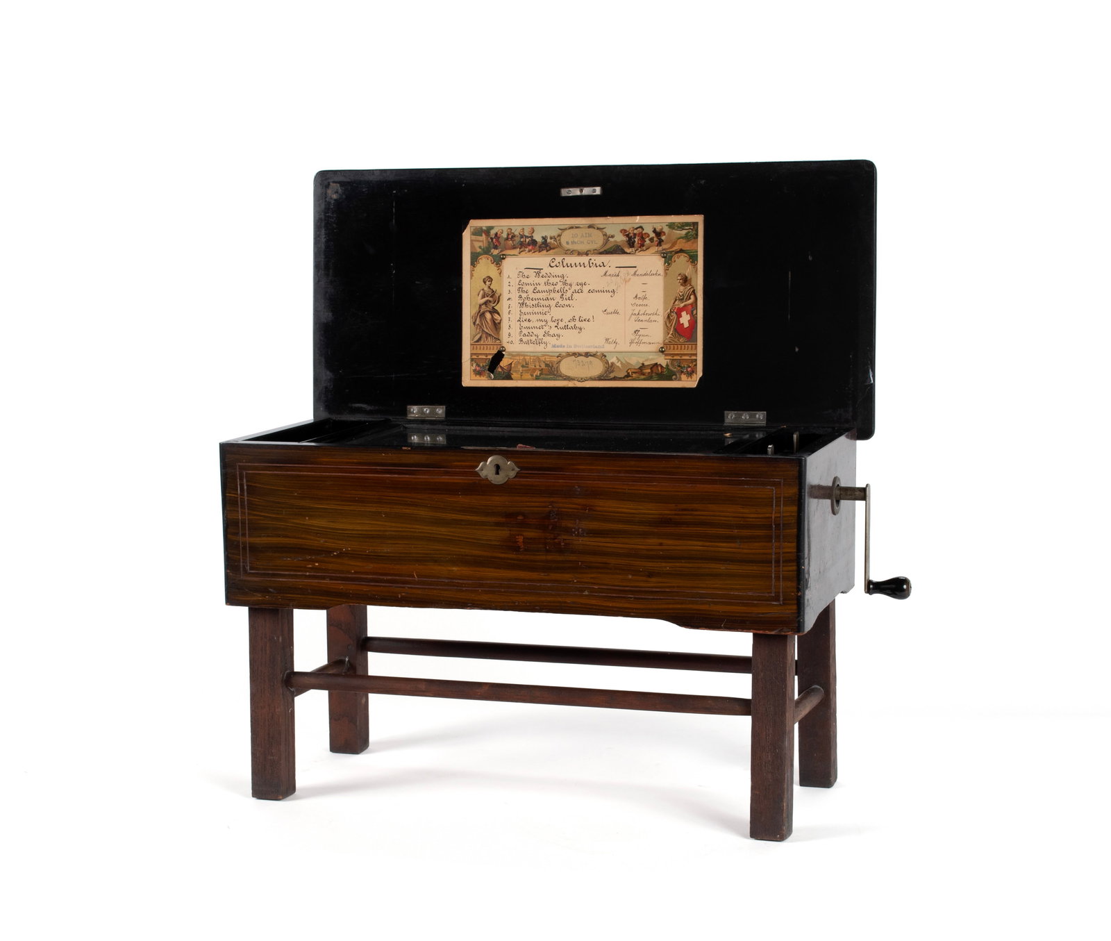 SWISS CYLINDER MUSIC BOX: SWISS CYLINDER MUSIC BOX Swiss, circa 1890s. Exotic wooden case with ebonized highlights, holding the 8" cylinder playing ten (10) songs with song titles listed on the period colorful lithograph