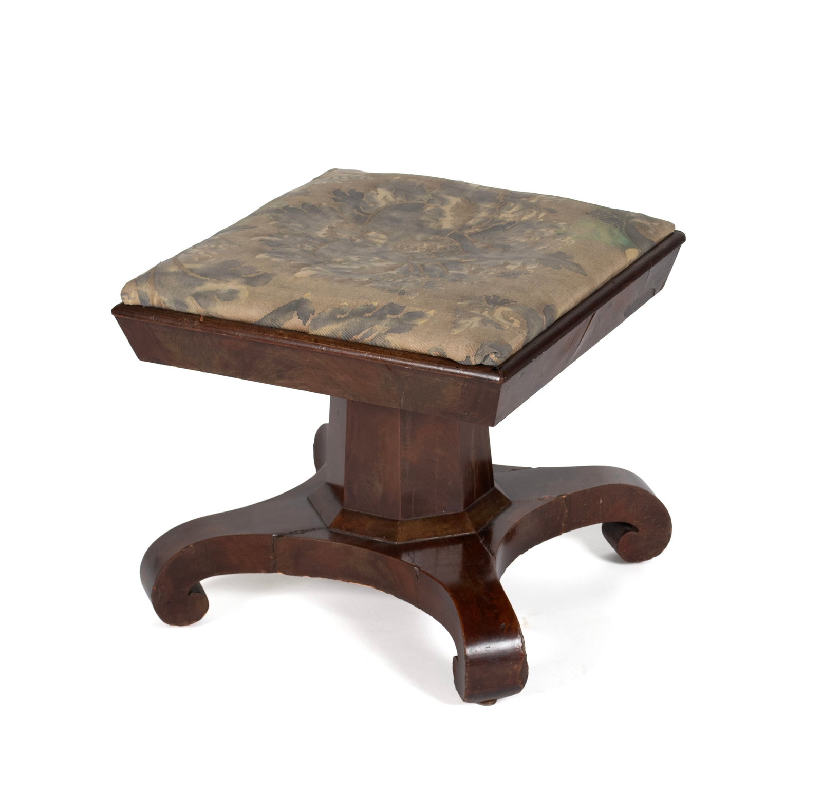 EMPIRE MAHOGANY UPHOLSTERED FOOTSTOOL: EMPIRE MAHOGANY UPHOLSTERED FOOTSTOOL 19th century. Mahogany veneered footstool on octagonal standard and four scrolling feet. 16 x 18 x 18 in. (40.6 x 45.7 x 45.7 cm.)
