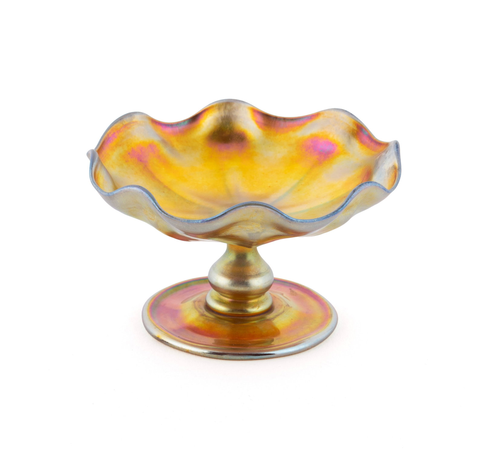 LOUIS COMFORT TIFFANY GOLD FAVRILE GLASS NUT DISH: LOUIS COMFORT TIFFANY GOLD FAVRILE GLASS NUT DISH American, early 20th century. Gold favrile glass footed nut dish with ruffled rim, signed 'L.C.T.' to underside. 2 1/2 x 4 1/4 in. (6.4 x 10.8 cm.)