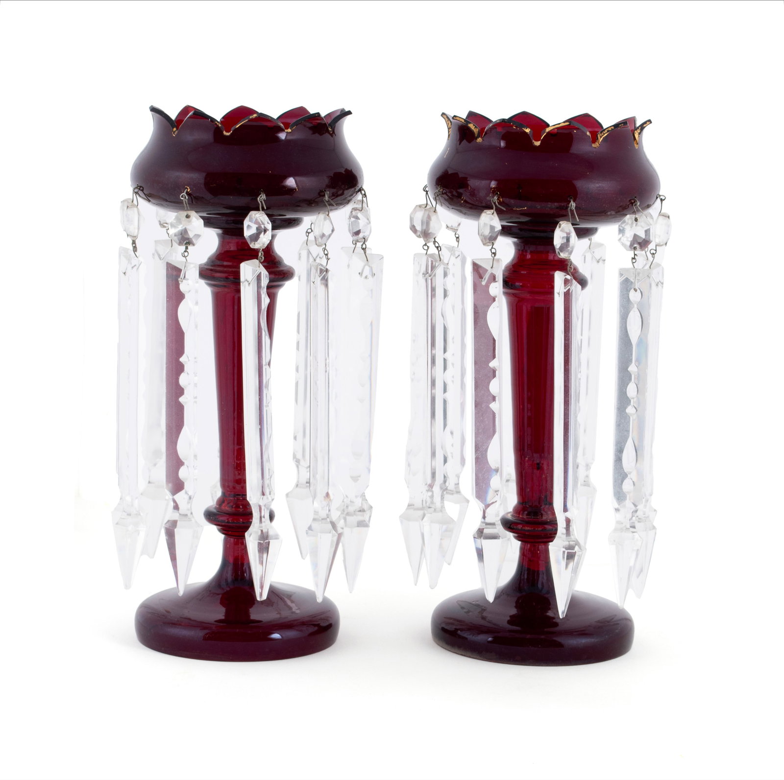 PAIR OF CRANBERRY GLASS LUSTERS: PAIR OF CRANBERRY GLASS LUSTERS Early 20th century. Pair of cranberry glass lusters with long prisms. Each: 13 1/2 x 6 in. (34.3 x 15.2 cm.)
