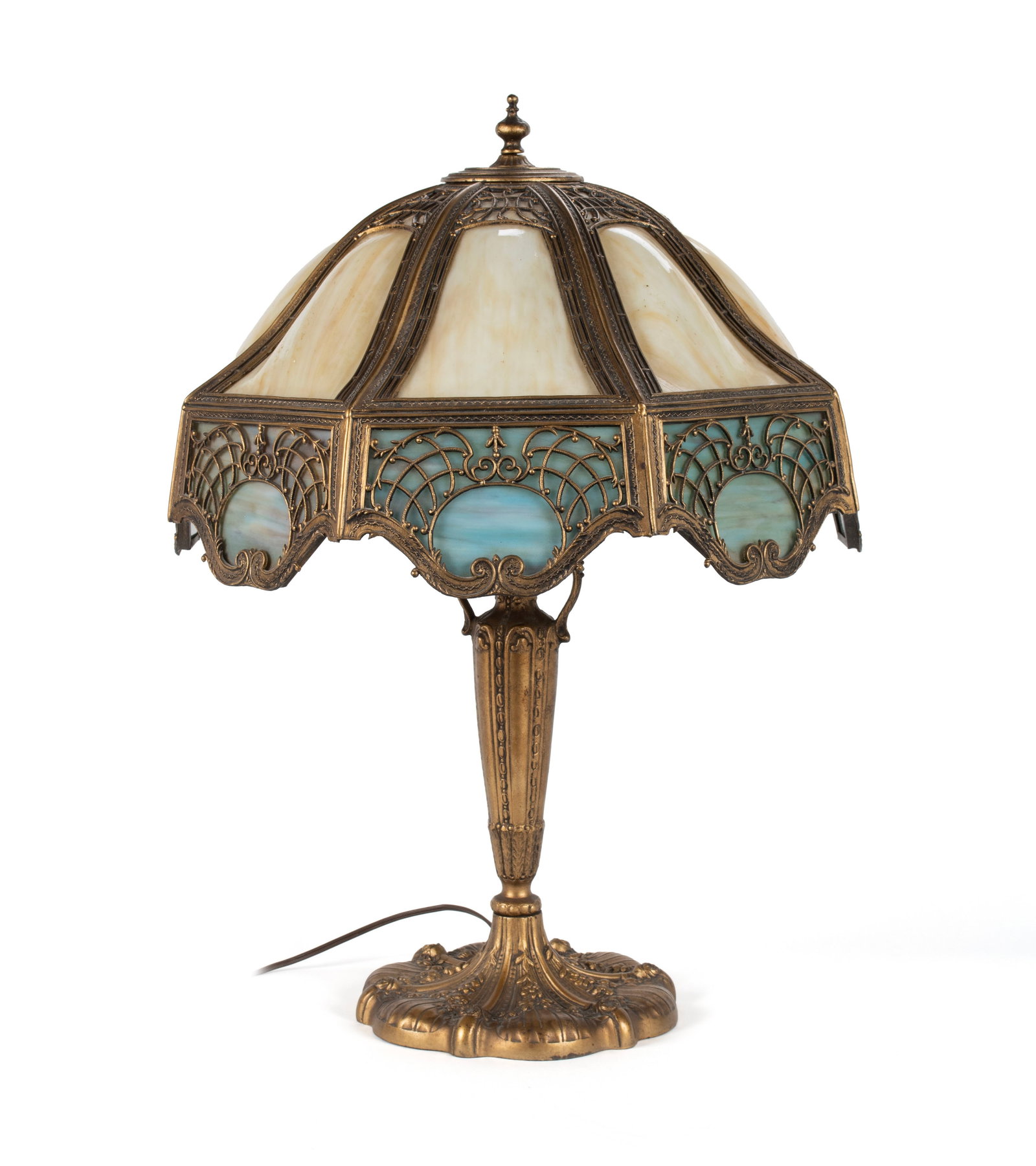SLAG GLASS TABLE LAMP: SLAG GLASS TABLE LAMP American, circa 1920s. Tan and blue slag glass shade on a gold finish base. 25 x 18 1/2 in. (63.5 x 47 cm.)