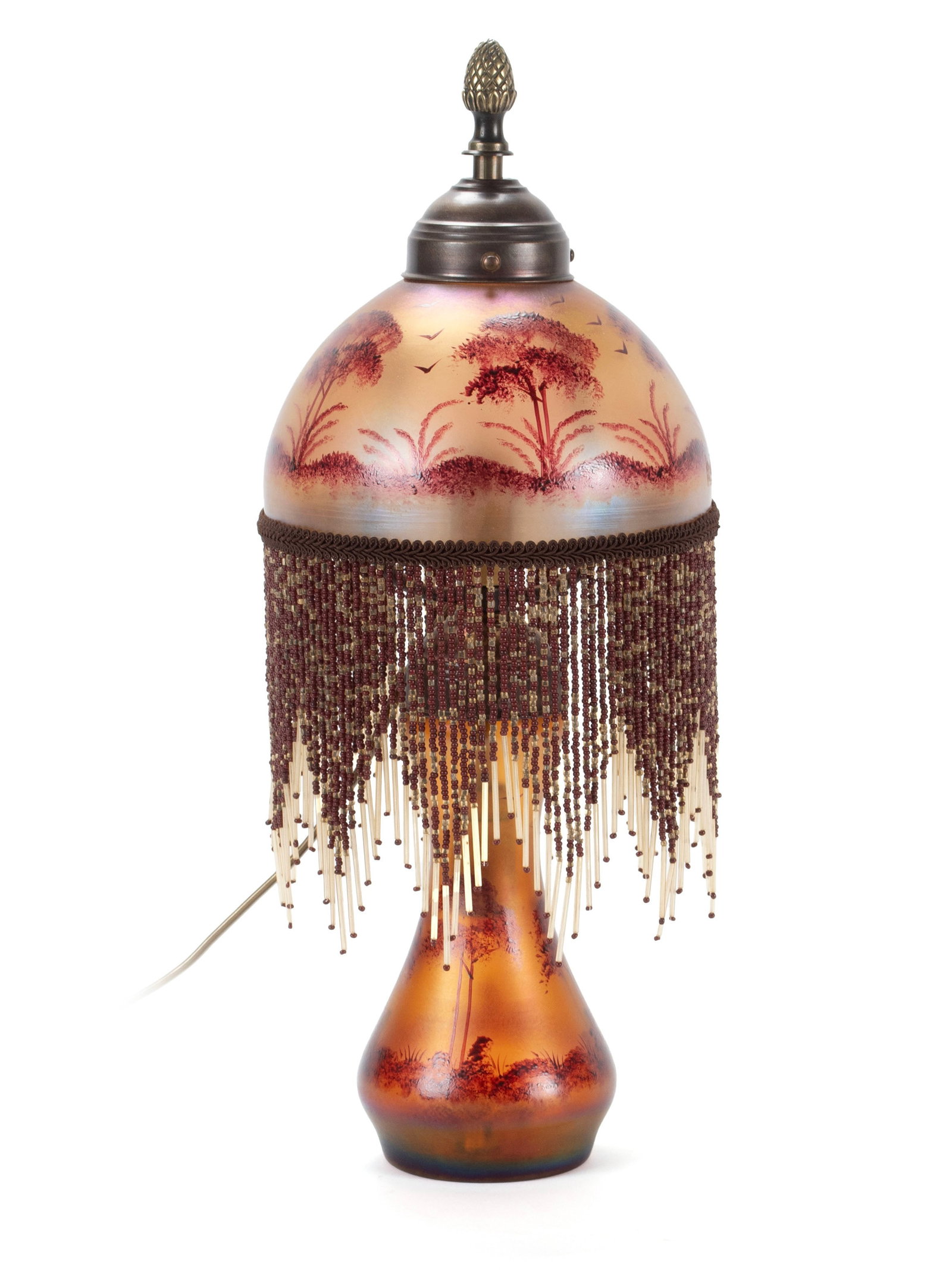 IRIDESCENT ART GLASS BOUDOIR LAMP: IRIDESCENT ART GLASS BOUDOIR LAMP American, mid-20th century. Domed hand painted shade decorated with trees and birds with all around decorative dangling beads, on the matching vasiform standard,
