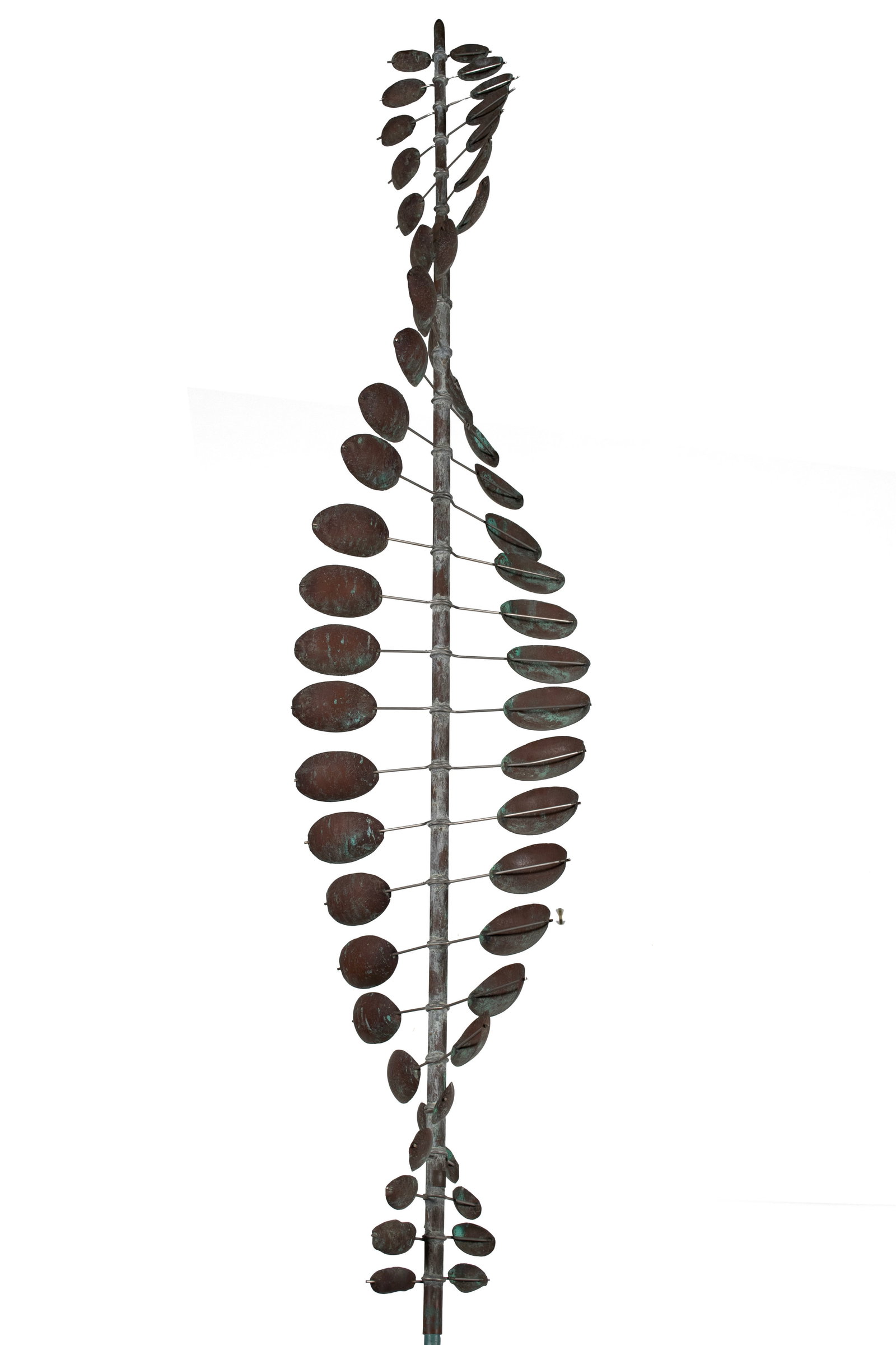 SPIRALING KINETIC WIND SCULPTURE: SPIRALING KINETIC WIND SCULPTURE American, 20th century, copper and white metal. Layers of alternating concave oval forms, spinning on the straight rod mount (in two parts). 136 in. (345.4 cm.)