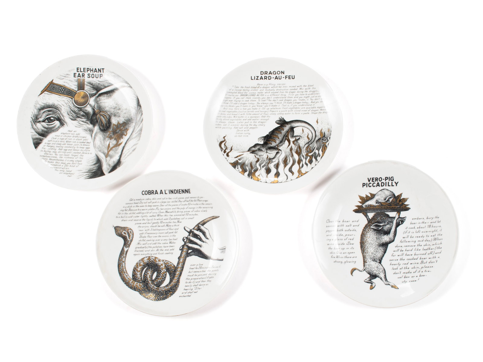 FOUR PIERO FORNASETTI PORCELAIN COOK PLATES FOR FLEMING JOFFE LTD: FOUR PIERO FORNASETTI PORCELAIN COOK PLATES FOR FLEMING JOFFE LTD Italian, 20th century. Four (4) recipe plates including "Elephant Ear Soup", "Dragon Lizard-Au-Feu", "Vero-Pig Piccadilly" and "Cobra 