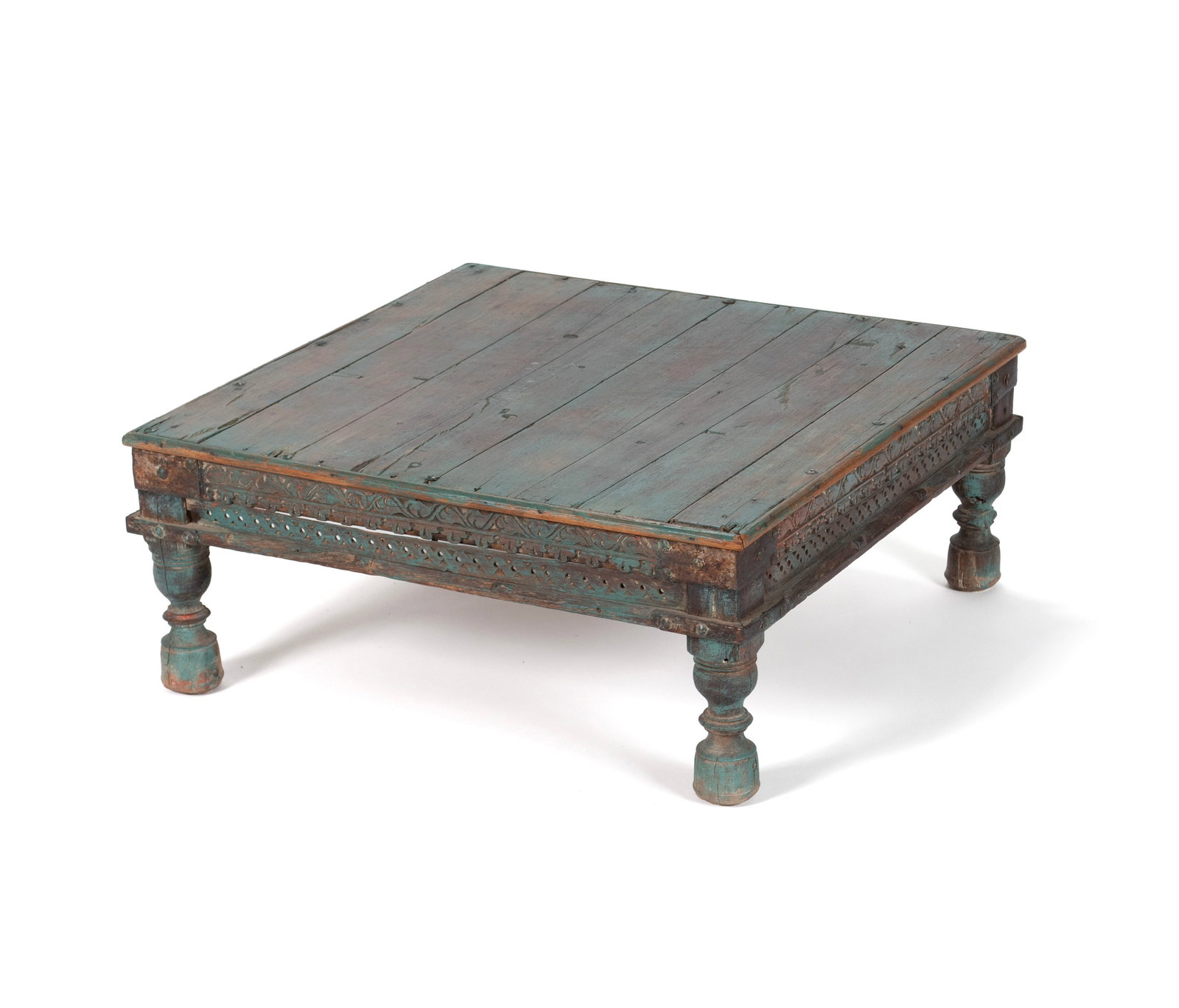 INDIAN CARVED LOW TABLE: INDIAN CARVED LOW TABLE Late 19th/early 20th century. Carved and painted wood platform table. 10 1/2 x 26 x 26 in. (26.7 x 66 x 66 cm.)