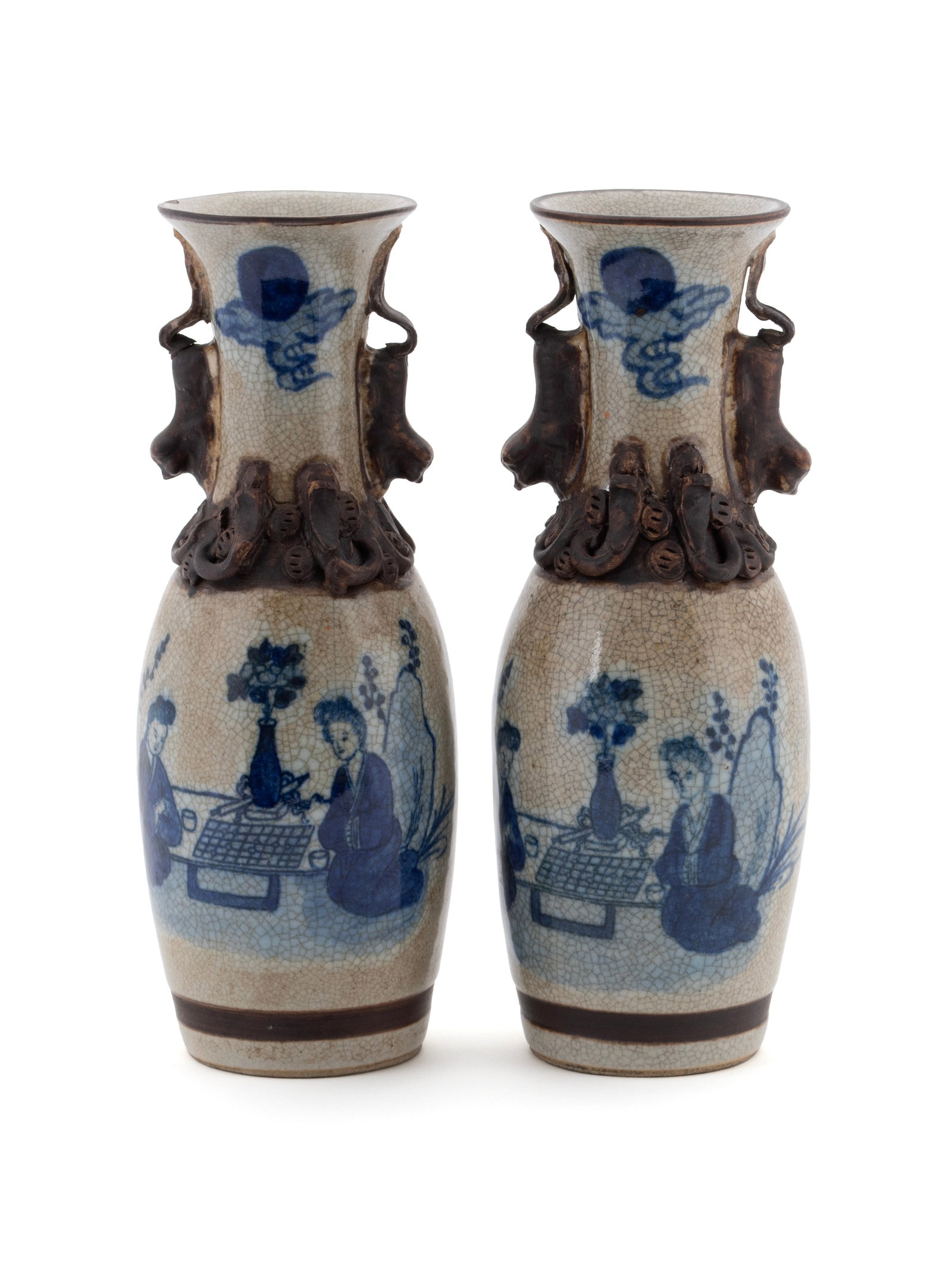 PAIR OF CHINESE BLUE AND WHITE CRACKLE GLAZED PORCELAIN VASES: PAIR OF CHINESE BLUE AND WHITE CRACKLE GLAZED PORCELAIN VASES Late Qing, Guangxu style. Decorated with interior scenes of two ladies playing Go, foo lion handles. Each: 11 1/4 x 4 in. (28.6 x 10.2