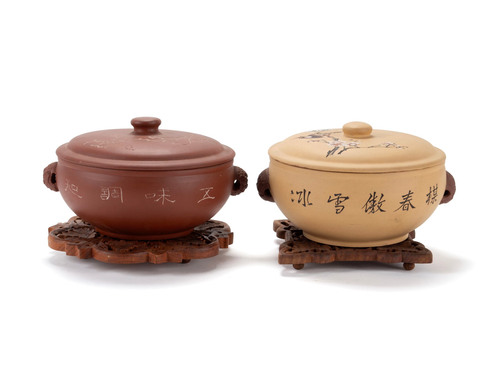 TWO YIXING COVERED POTS: TWO YIXING COVERED POTS 20th century. Two covered steamer pots with incised and painted decoration, one with impressed seal. On associated wooden trivets. Each: 5 x 8 1/2 in. (12.7 x 21.6 cm.)