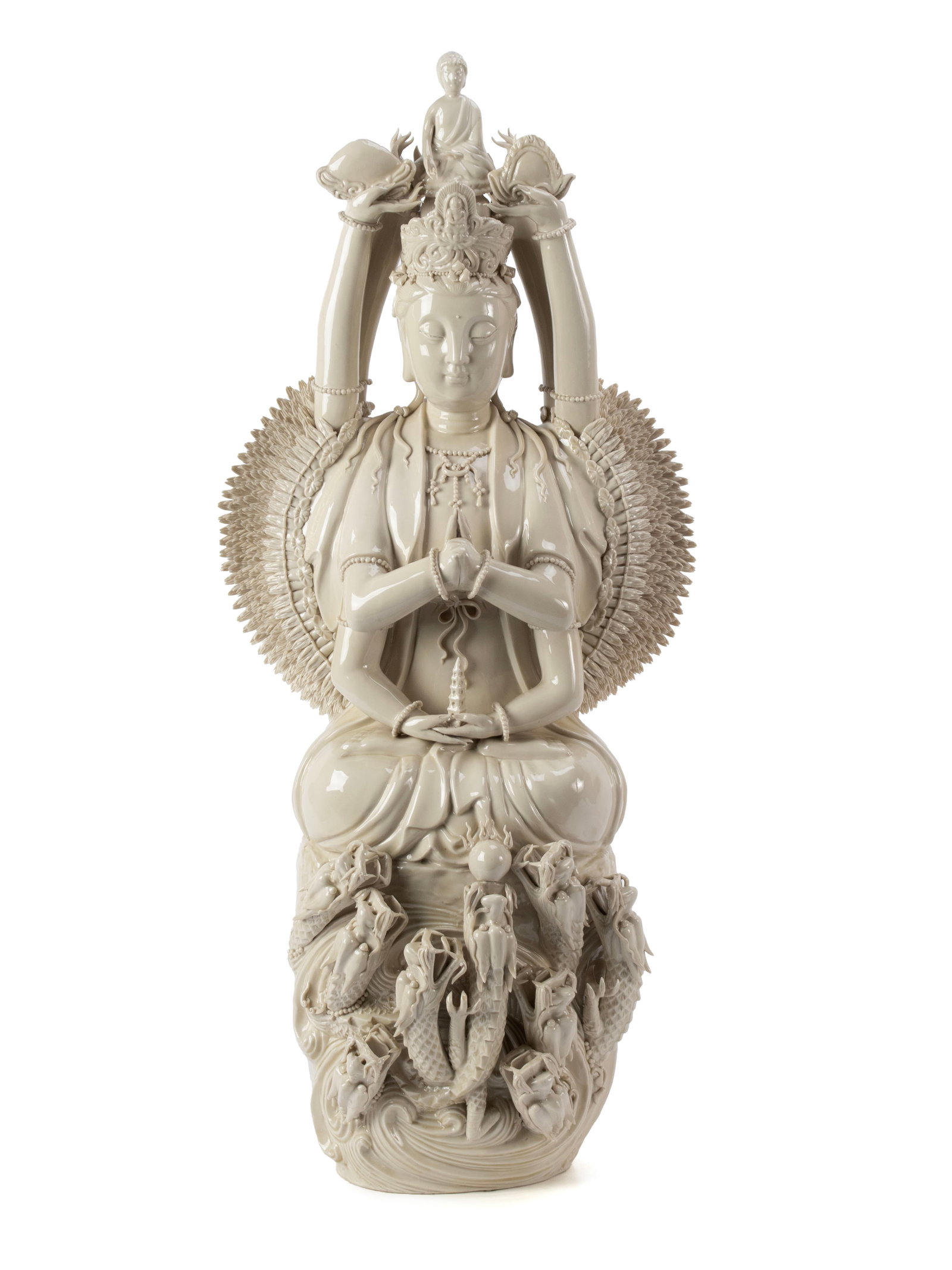 BLANC DE CHINE BODHISATTVA: BLANC DE CHINE BODHISATTVA Chinese, 20th century. Depicts Quan Yin, the goddess of compassion, in the thousand-arm form, with a Buddha figure a top her head, seated on a base surrounded by dragons.