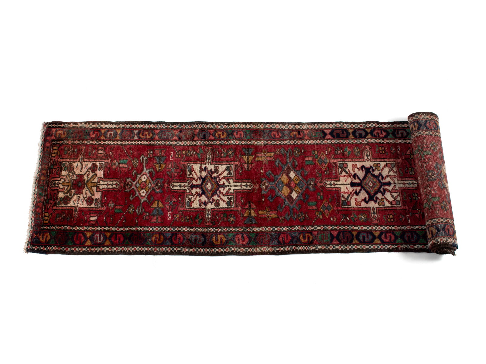 KARAJA LONG RUG: KARAJA LONG RUG Persian, 20th century. Five large ivory medallions run the red field, colorful geometric border with guard borders. 11 ft. 2 in. x 2 ft. 2 in.