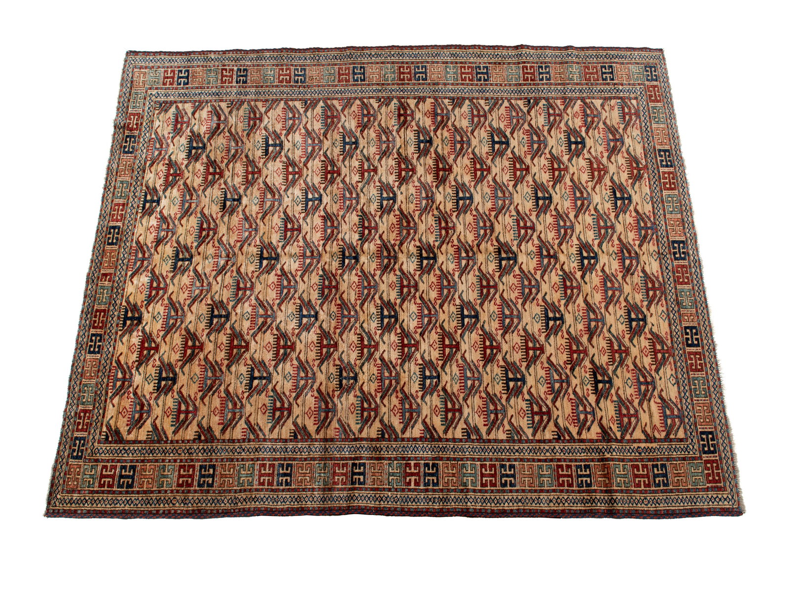 PAK KAZAK HALL RUG: PAK KAZAK HALL RUG Pakistani, 20th century. Rows of red and blue 'winged' medallions cover the beige field; colorful geometric medallions decorated the ivory primary border with guard borders. 8 ft. 9