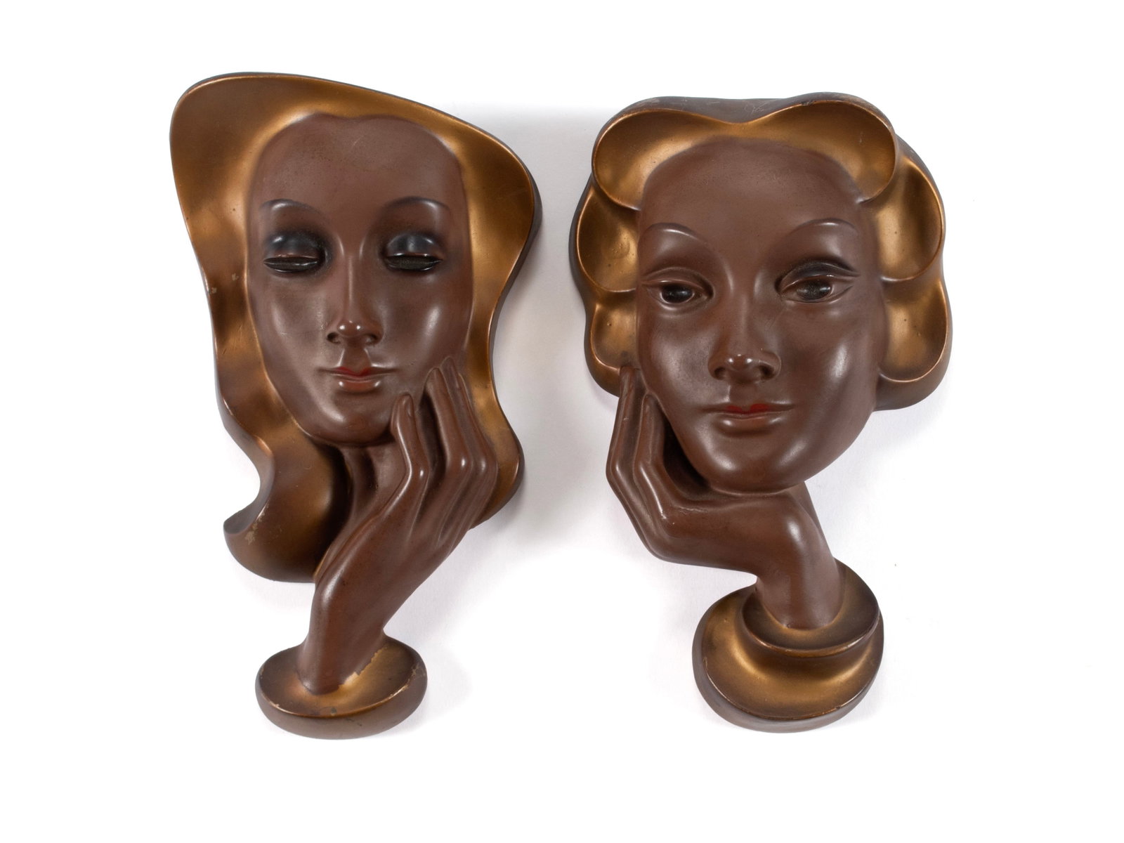 PAIR OF ART DECO WALL PORTRAITS: PAIR OF ART DECO WALL PORTRAITS 20th century. Pair of painted plaster wall masks. 10 x 5 3/4 in. (25.4 x 14.6 cm.)