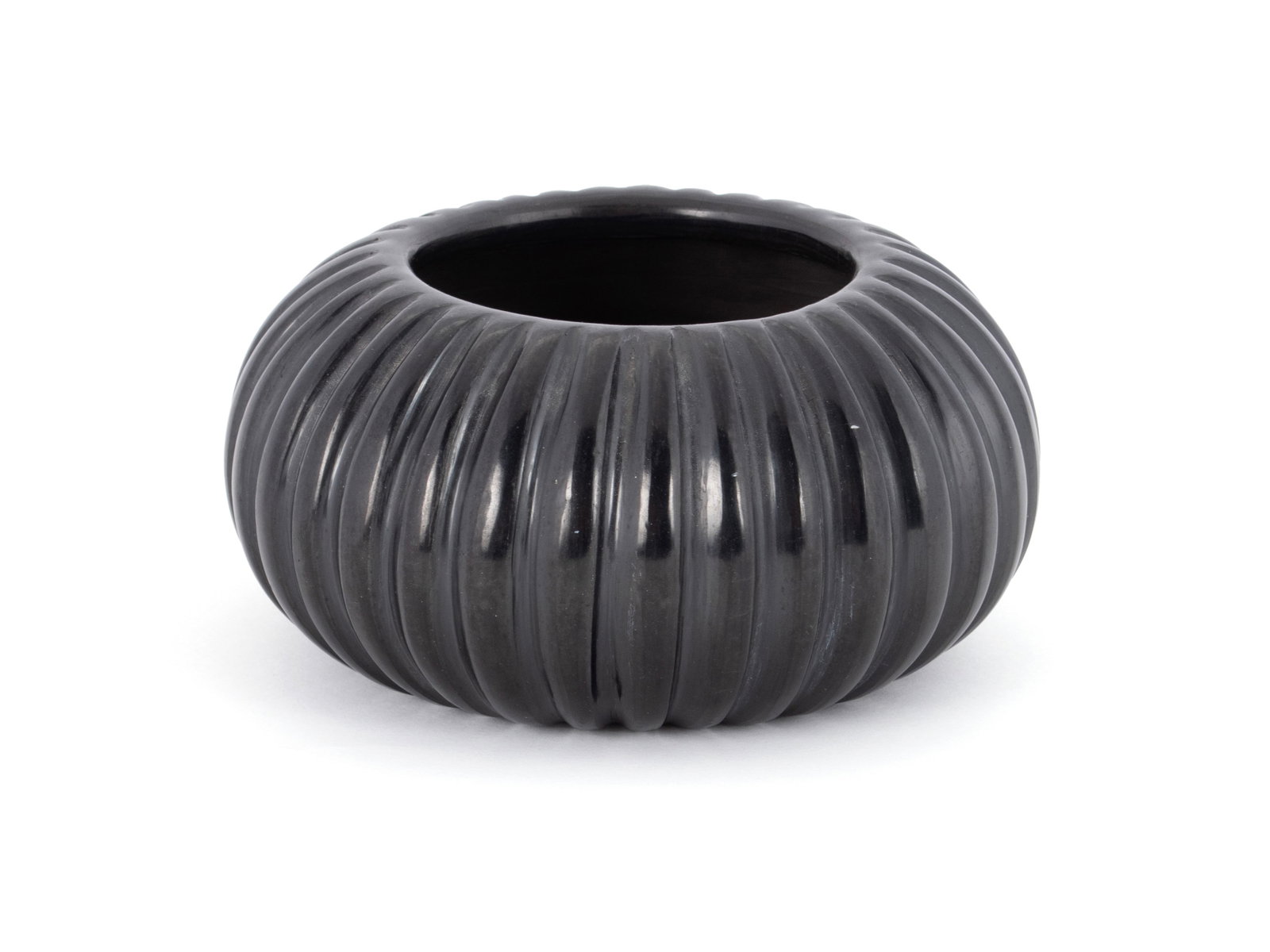 ANGELA BACA (1927-2014) BLACKWARE MELON JAR: ANGELA BACA (1927-2014) BLACKWARE MELON JAR Santa Clara, 20th century. Signed on underside. 3 1/4 x 6 1/2 in. (8.3 x 16.5 cm.) The Collection of Mrs. Mary Jane Bodine, formerly Mrs. Mary Jane Gury.